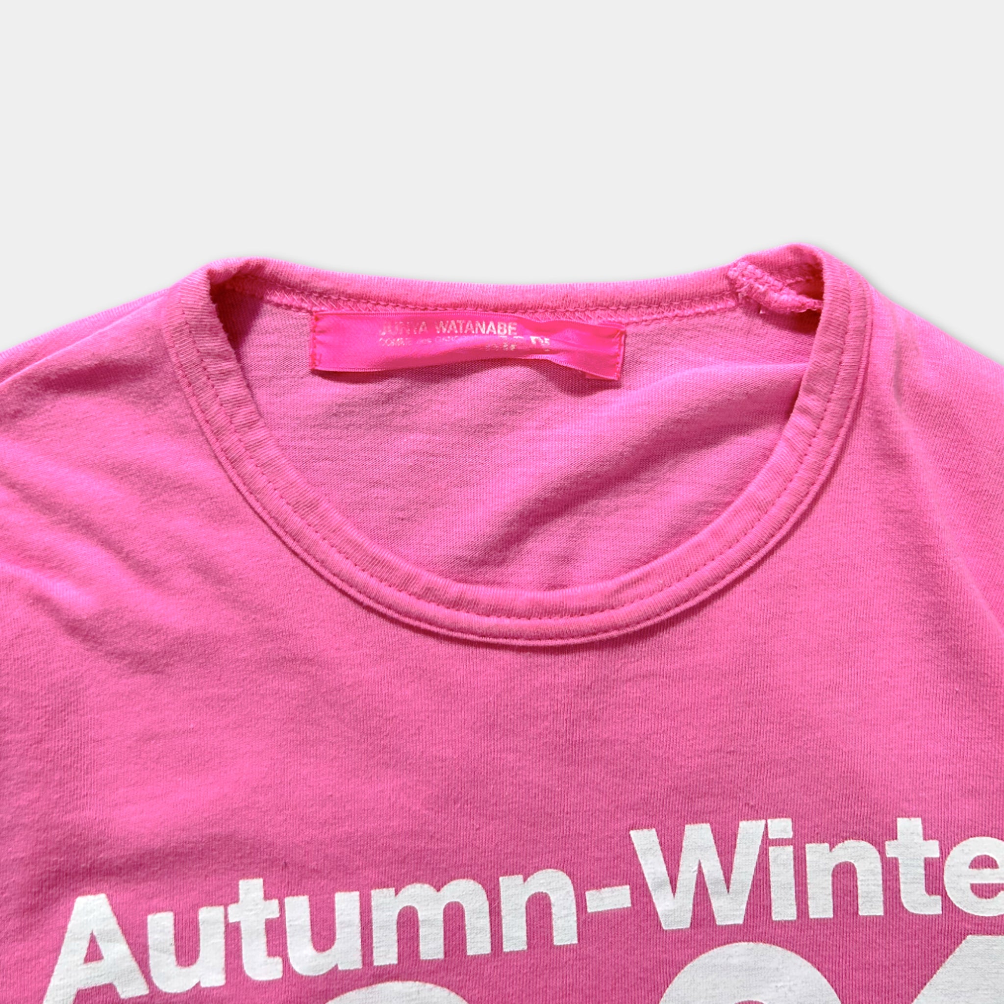 A pink t-shirt with the text "Autumn-Winter" printed on it.