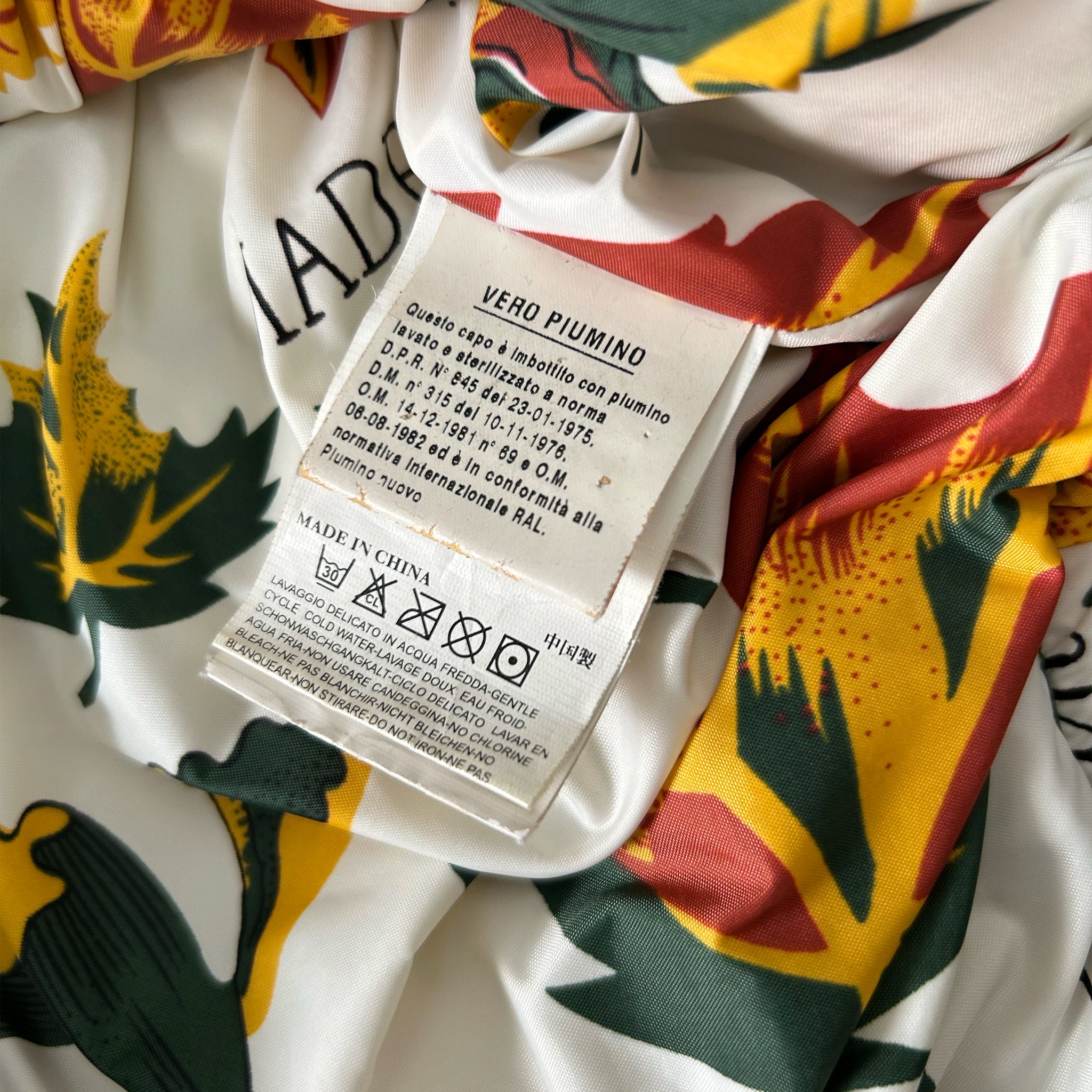 a close-up view of a fabric label with text and symbols, likely providing information about the product.