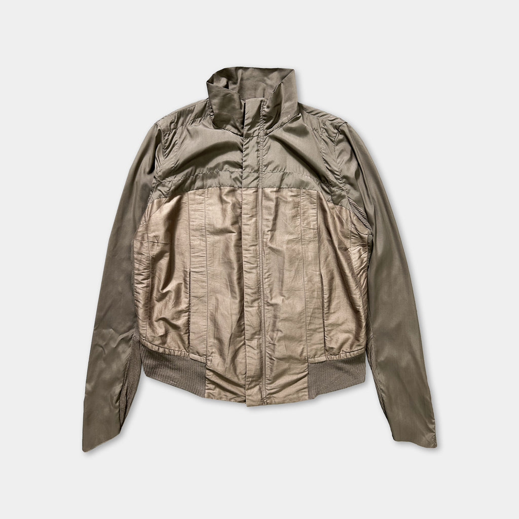 A beige jacket with a high collar and long sleeves, displayed against a white background.