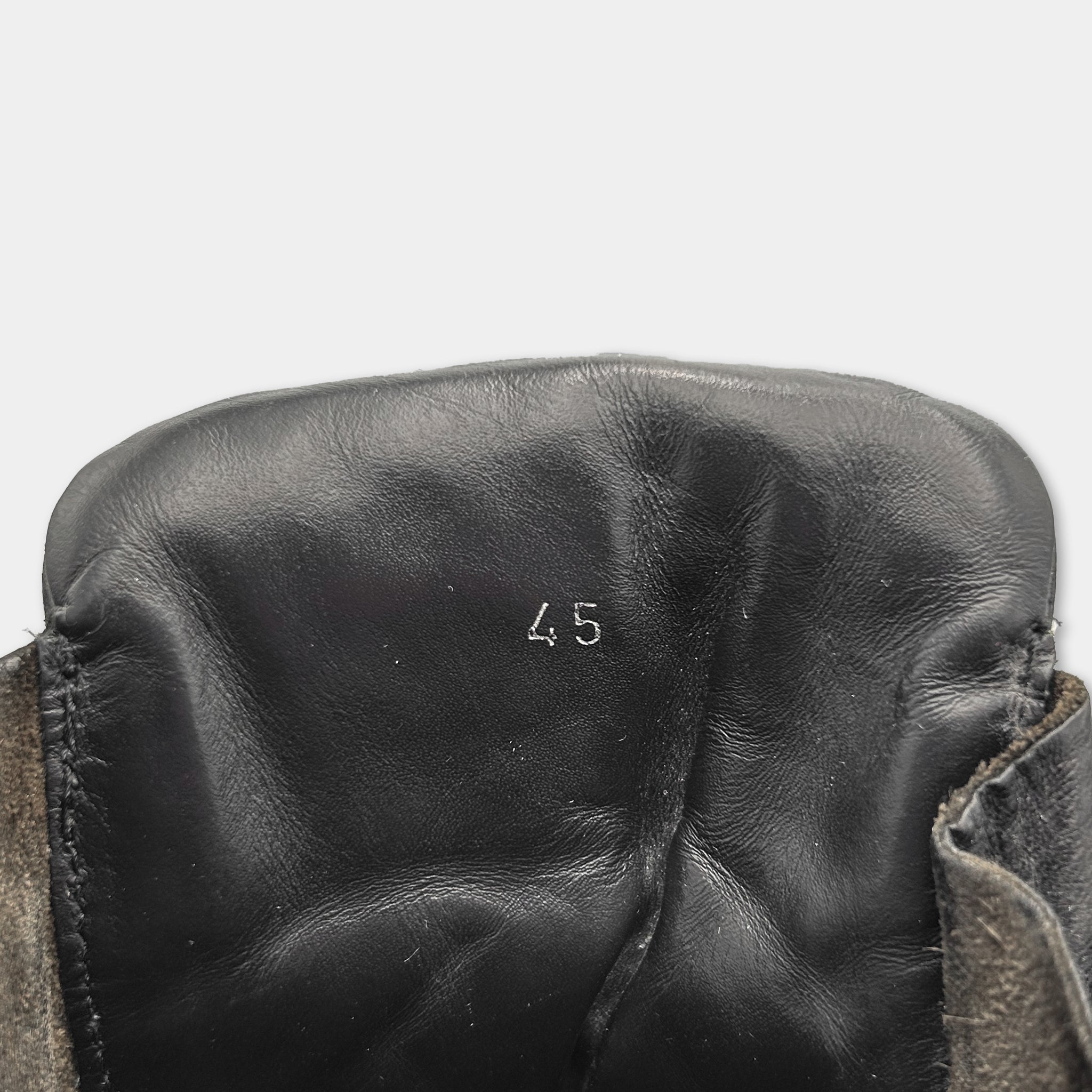 A close-up view of a black leather shoe sole, with the number "45" printed on it.