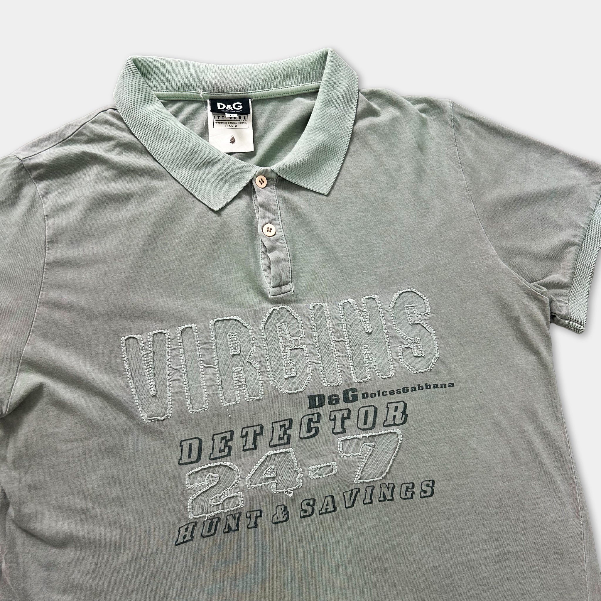 A gray polo shirt with the text "VIRGINS" and "DETECTOR 24-7 HUNT & SAVINGS" printed on it.