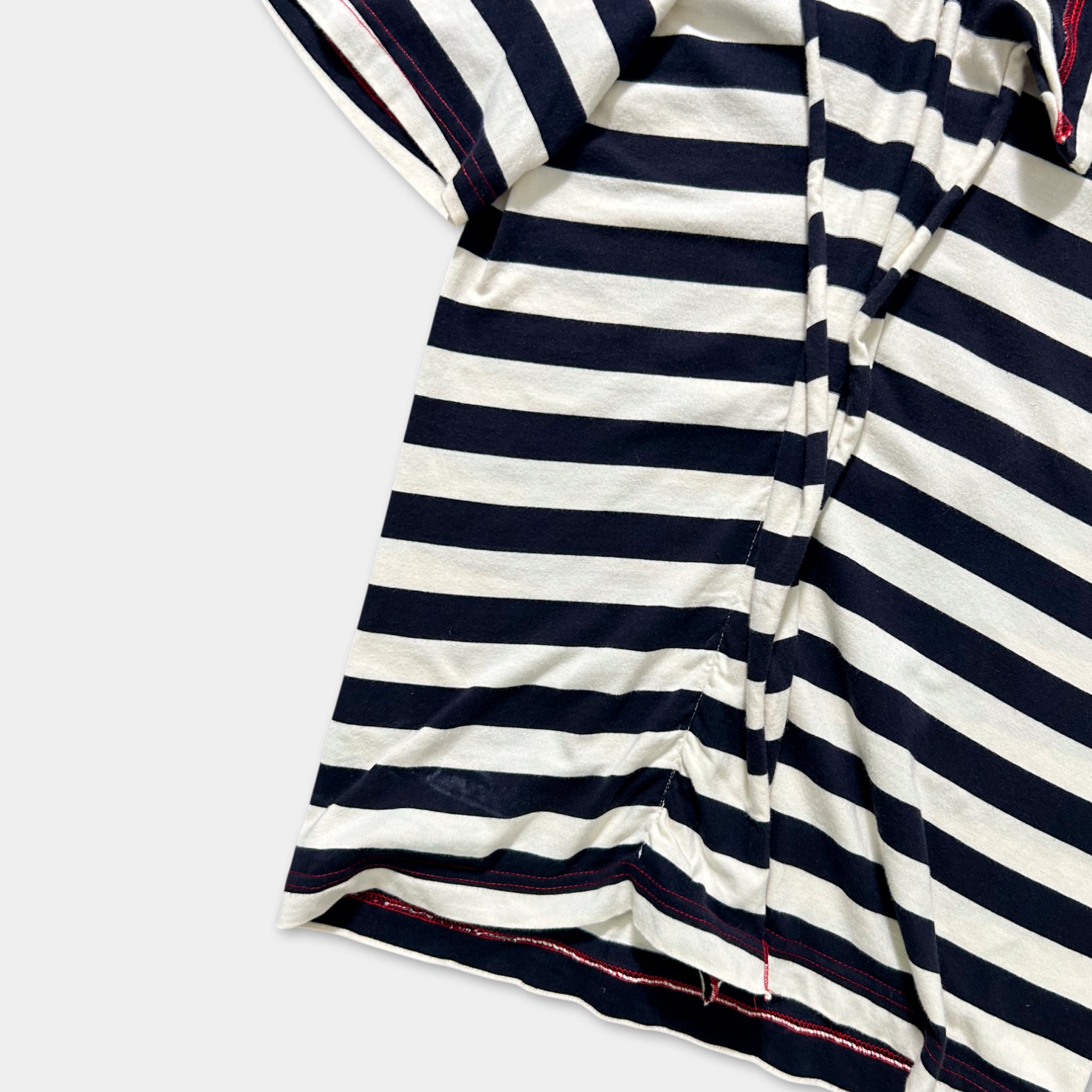A close-up view of a striped shirt with a dark blue and white pattern.