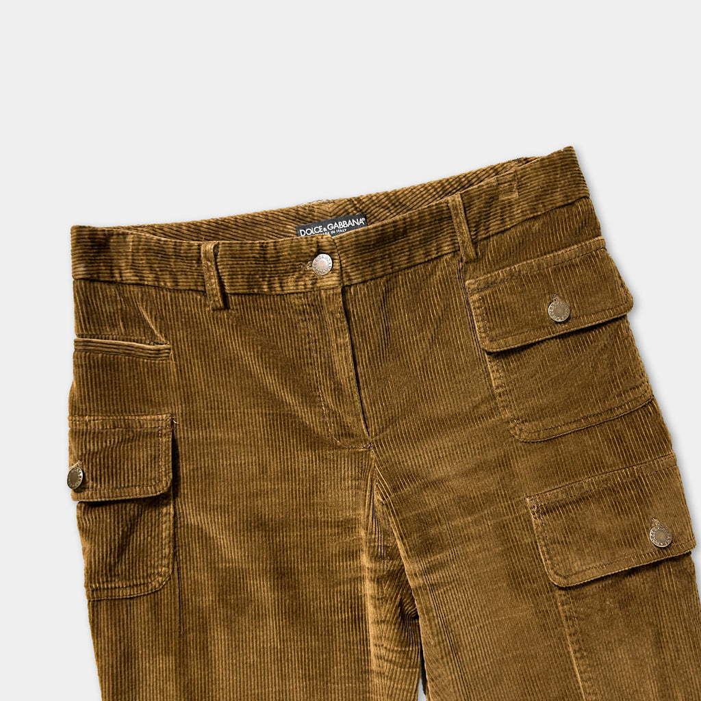 A pair of brown corduroy pants with pockets and a belt.