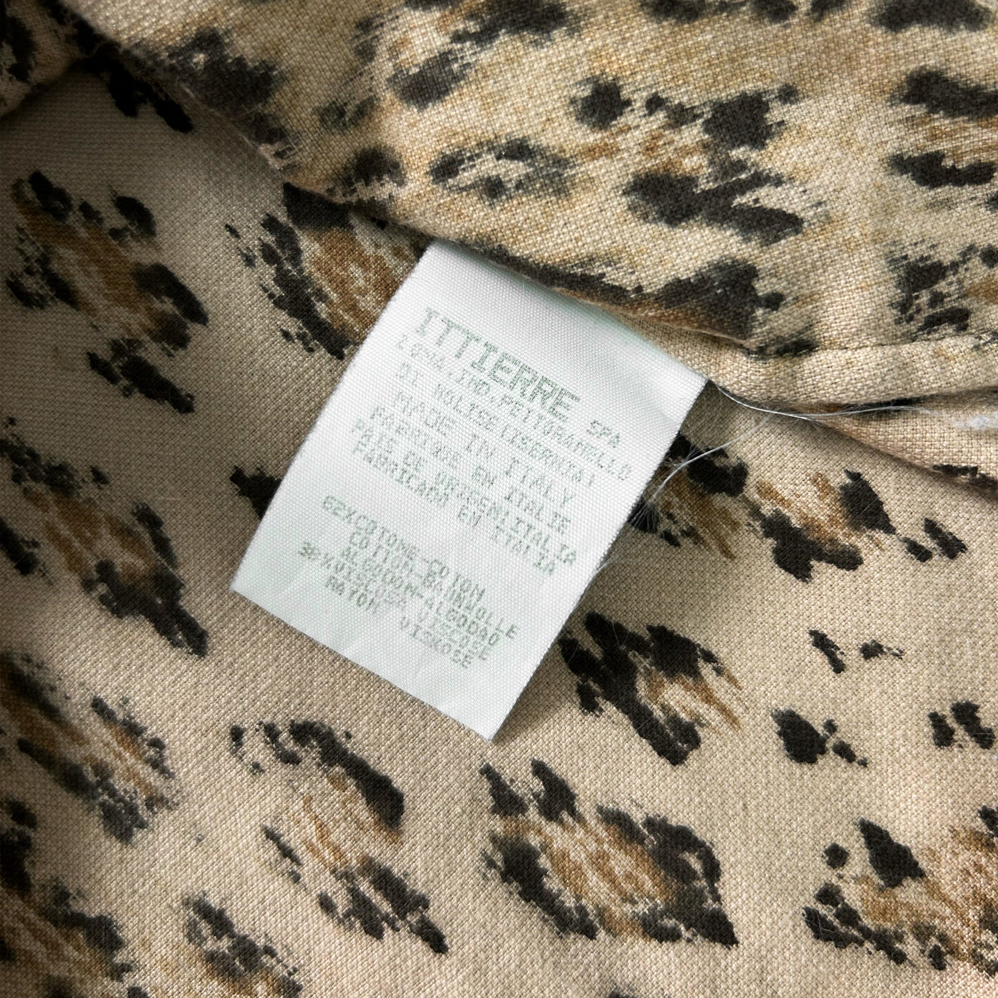 a close-up view of a fabric label with a leopard print pattern.