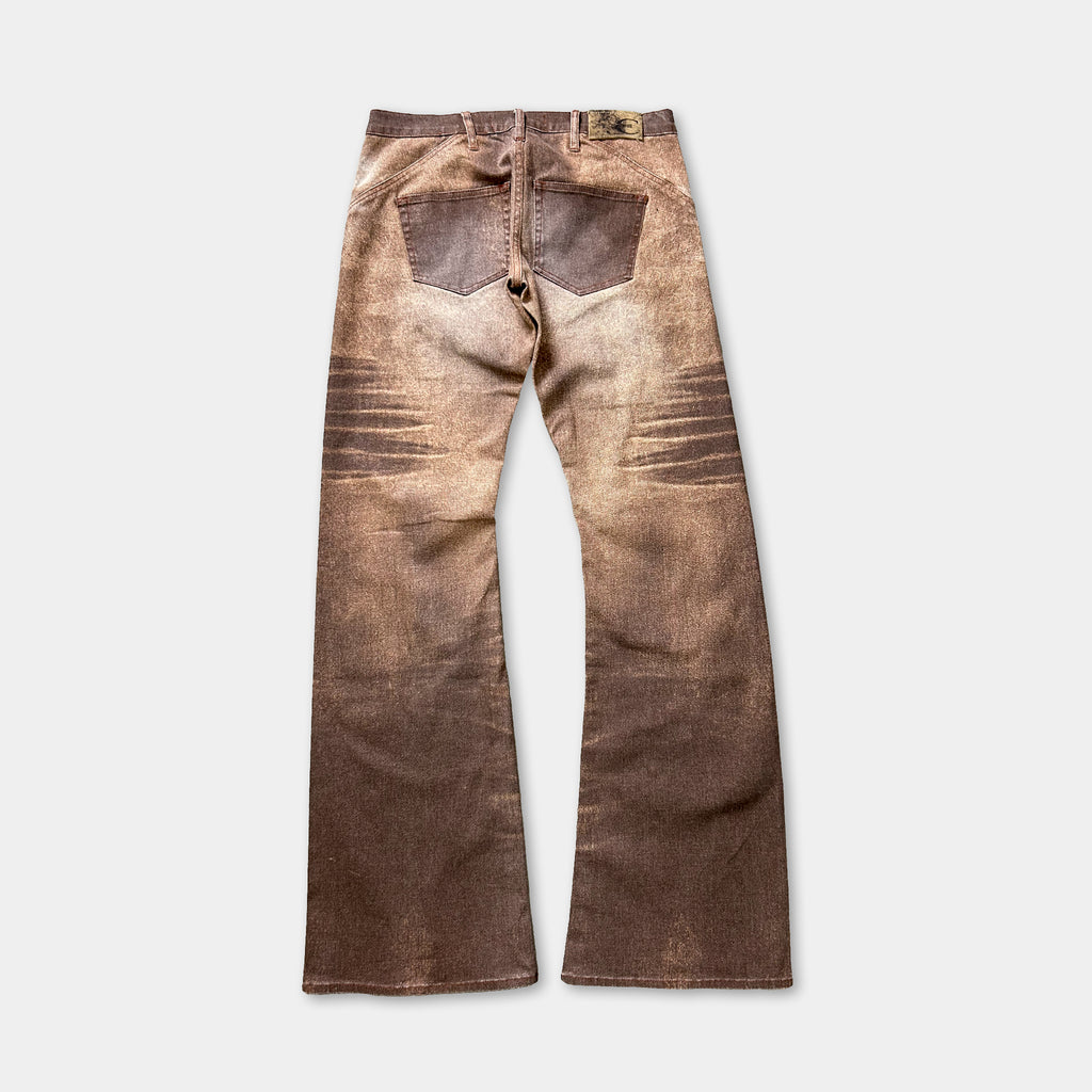 A pair of brown, distressed jeans with a faded appearance.