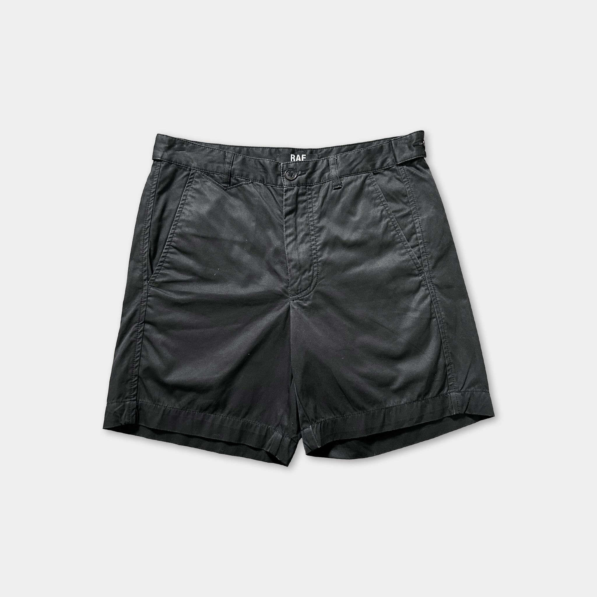 A pair of black shorts against a white background.