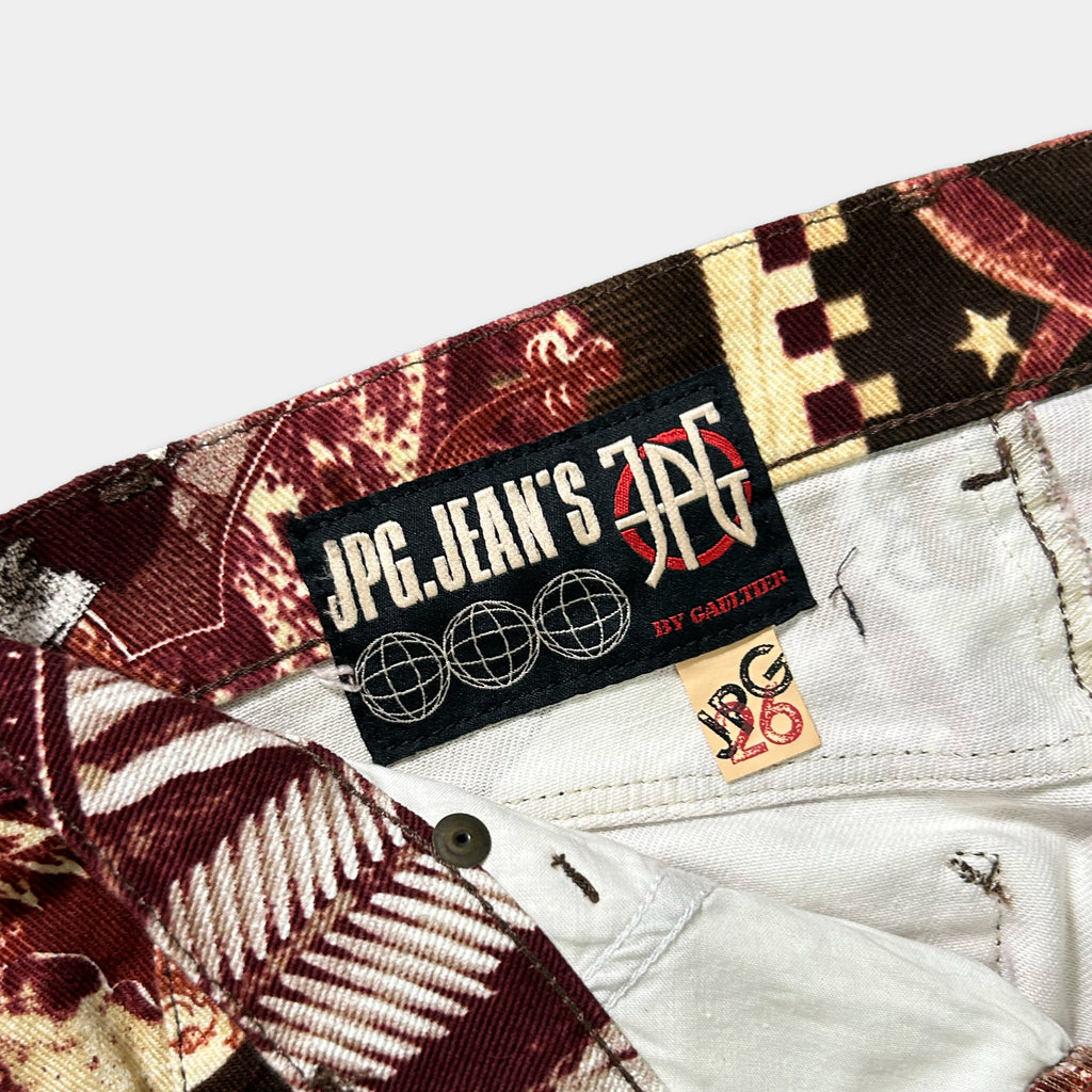 a close-up view of a pair of patterned jeans, with a label attached to the waistband.