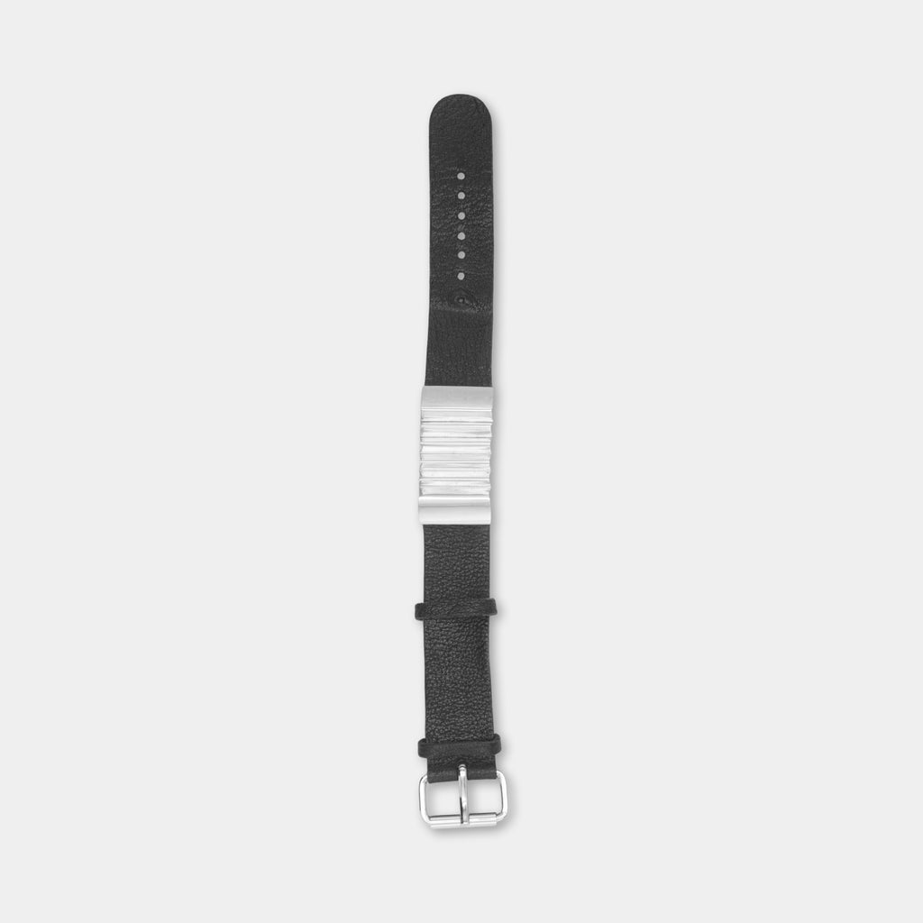 A black leather watch strap with a silver buckle and buckle holes.