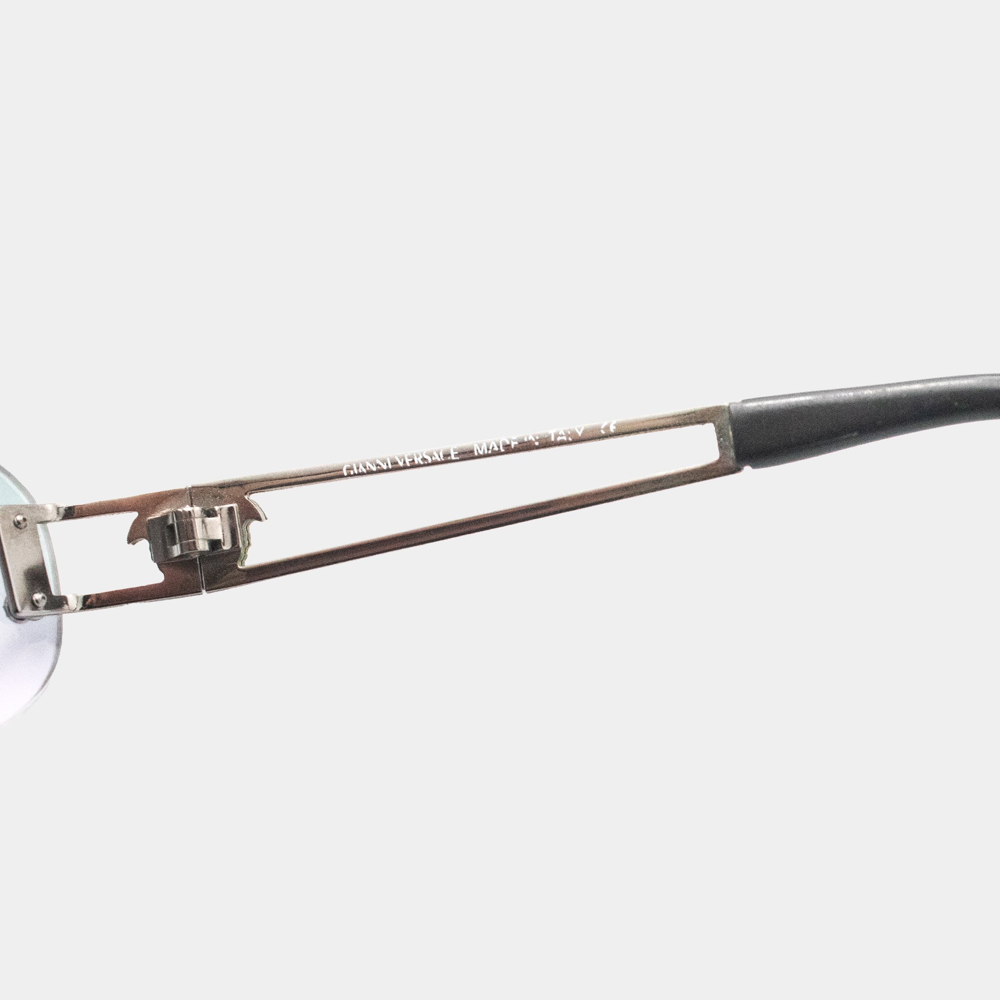 A close-up view of a pair of eyeglasses with a black frame and silver metal frame.