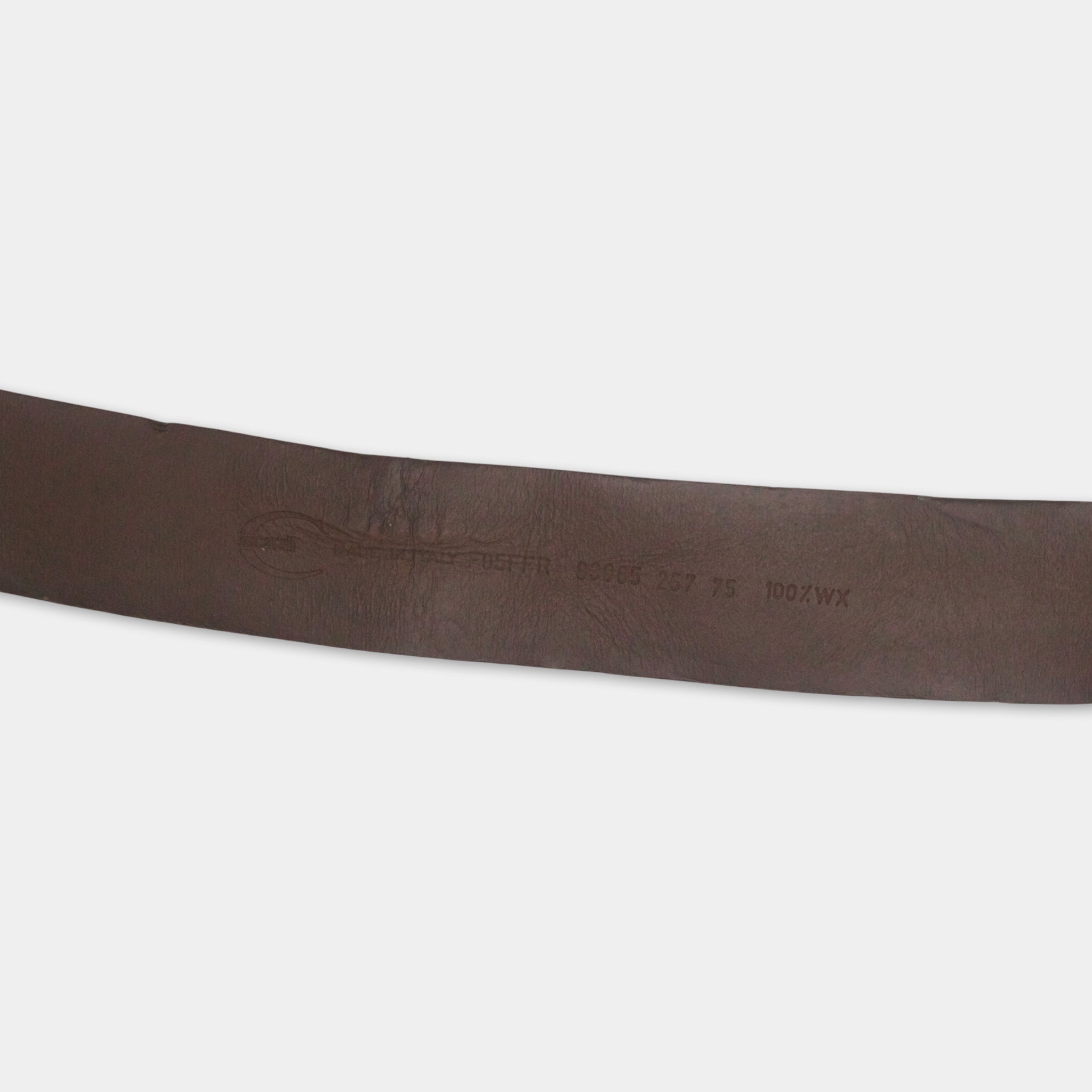 A close-up view of a brown leather belt with embossed text and numbers.
