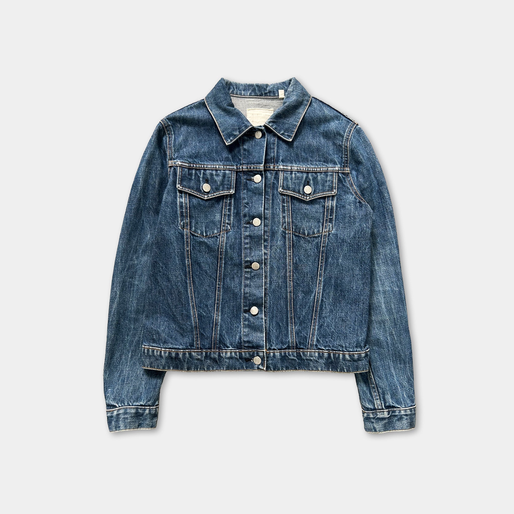 A denim jacket with a button-down front and long sleeves, displayed against a plain background.