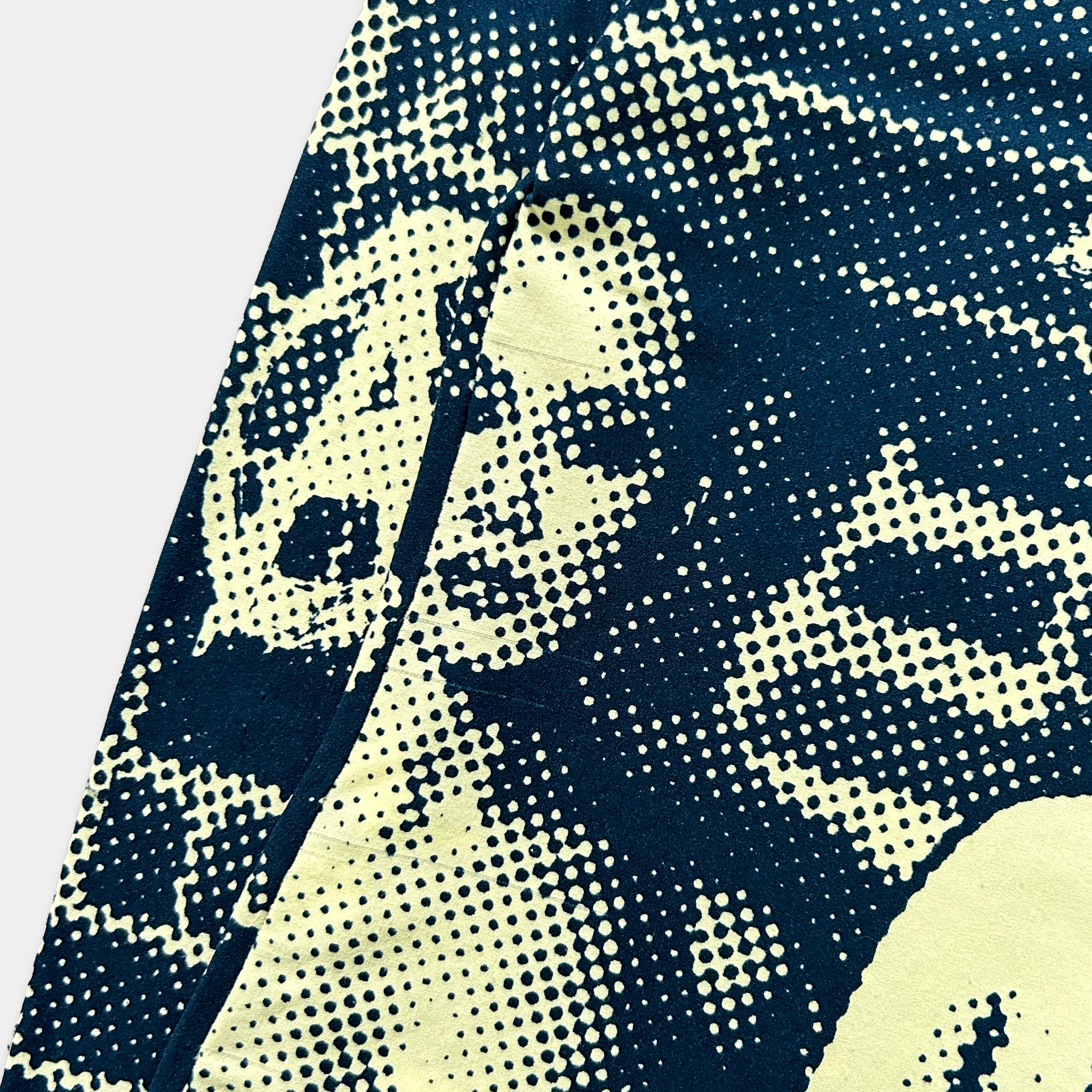 a close-up view of a patterned fabric with a black and white design, resembling a pop art style.