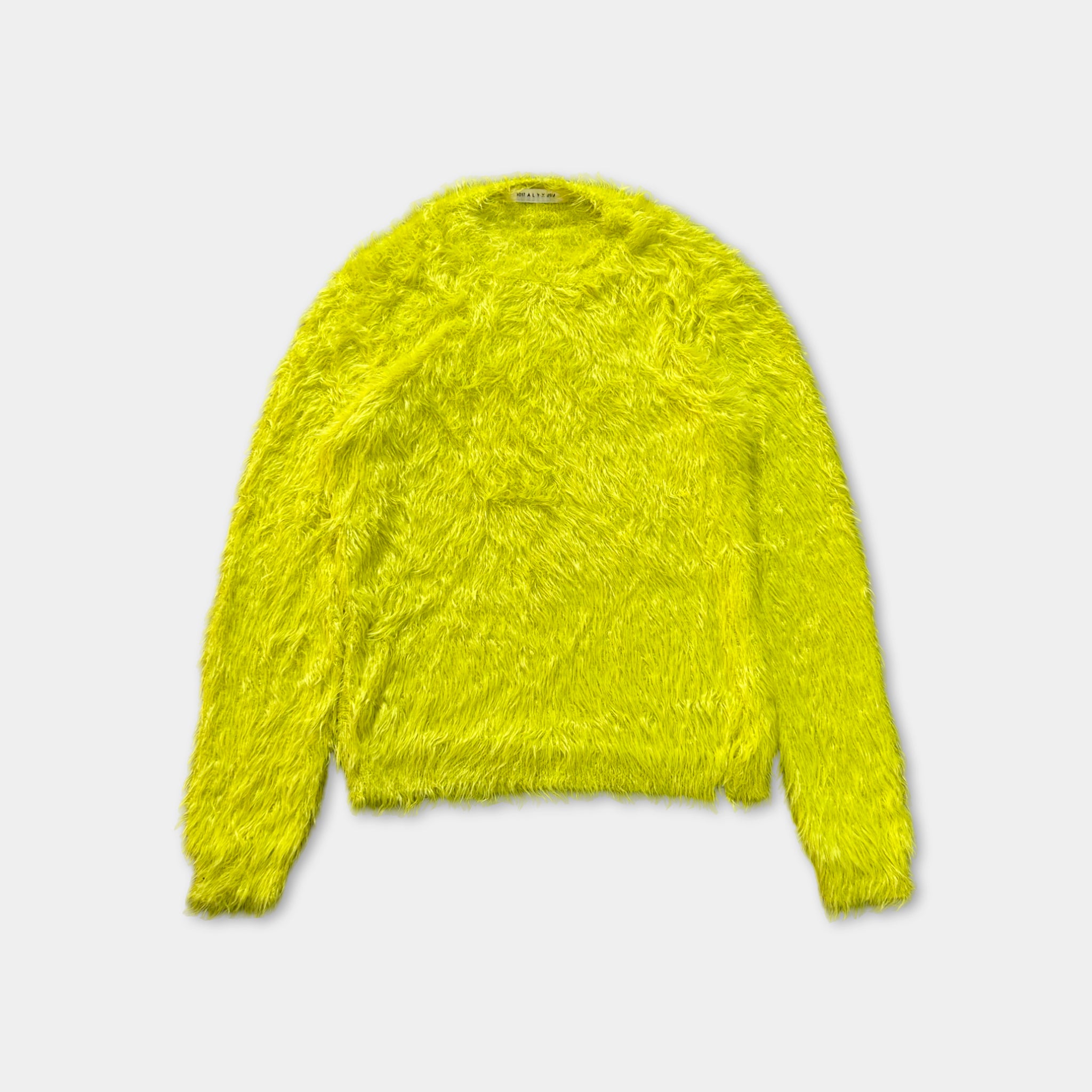 A bright yellow fuzzy sweater is displayed against a white background.