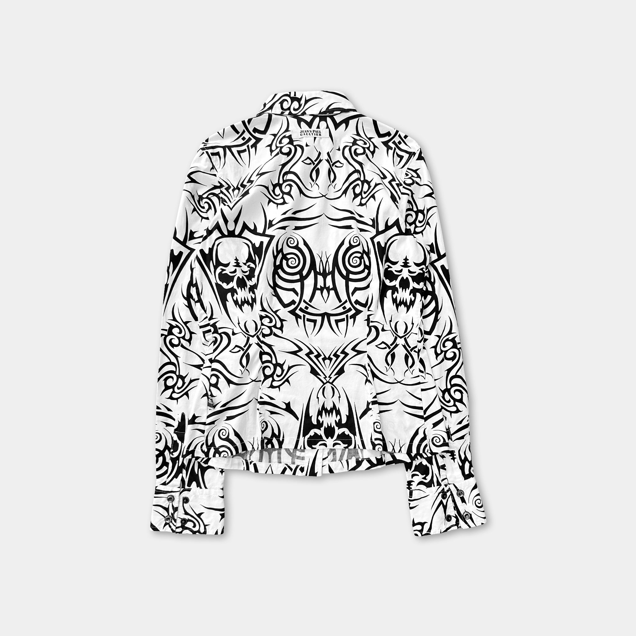a black and white patterned shirt with a skull and crossbones design.