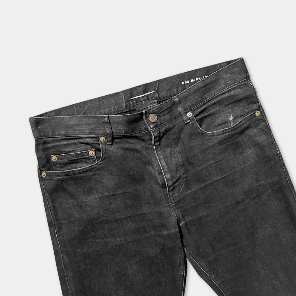 A pair of black jeans with a dark wash pattern.