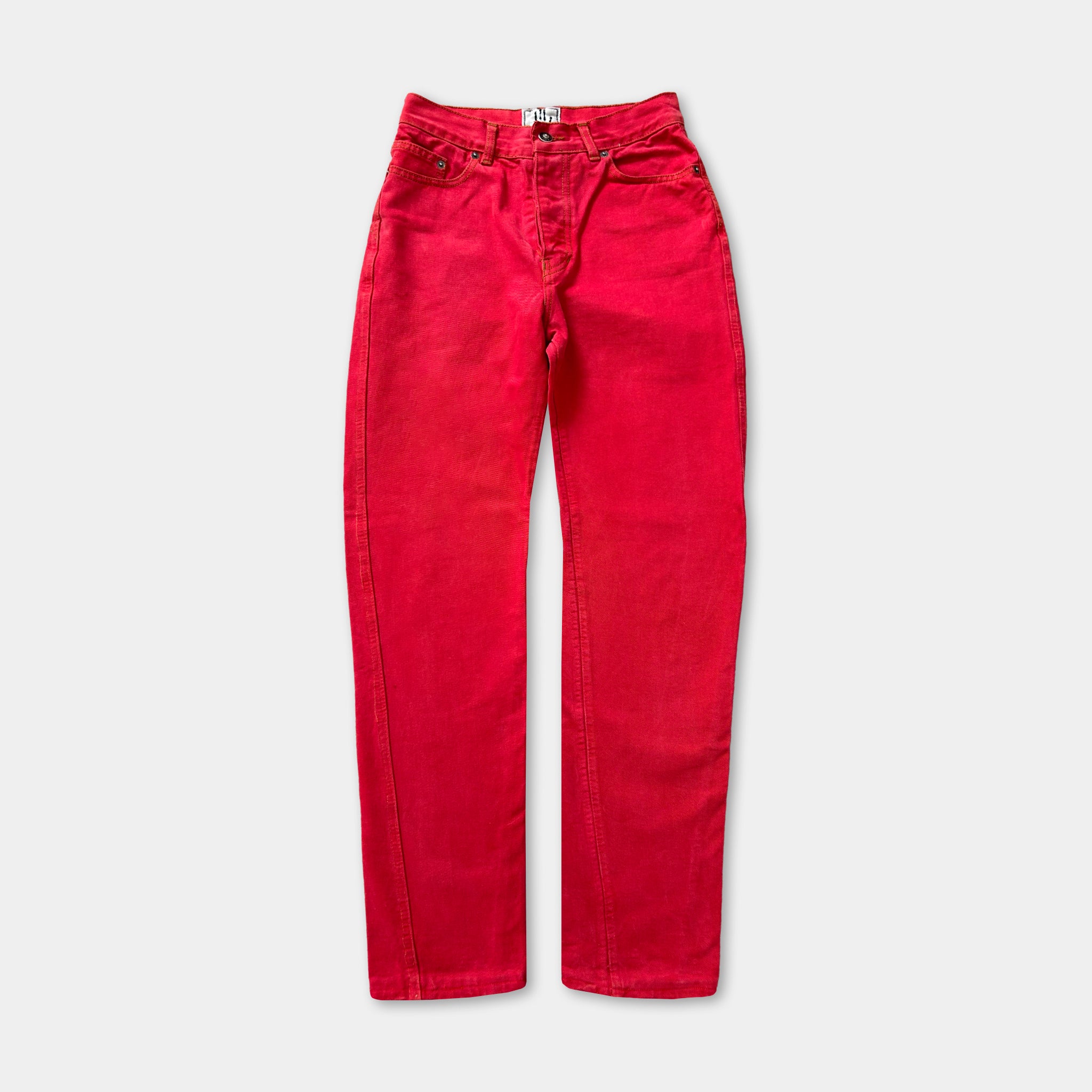 A pair of bright red jeans with a high-waisted design.