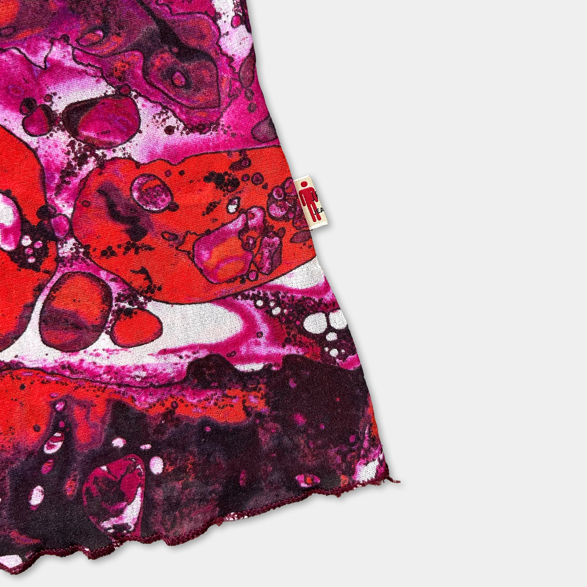 a vibrant, abstract pattern with a mix of red, pink, and purple colors, creating a visually striking and dynamic design.