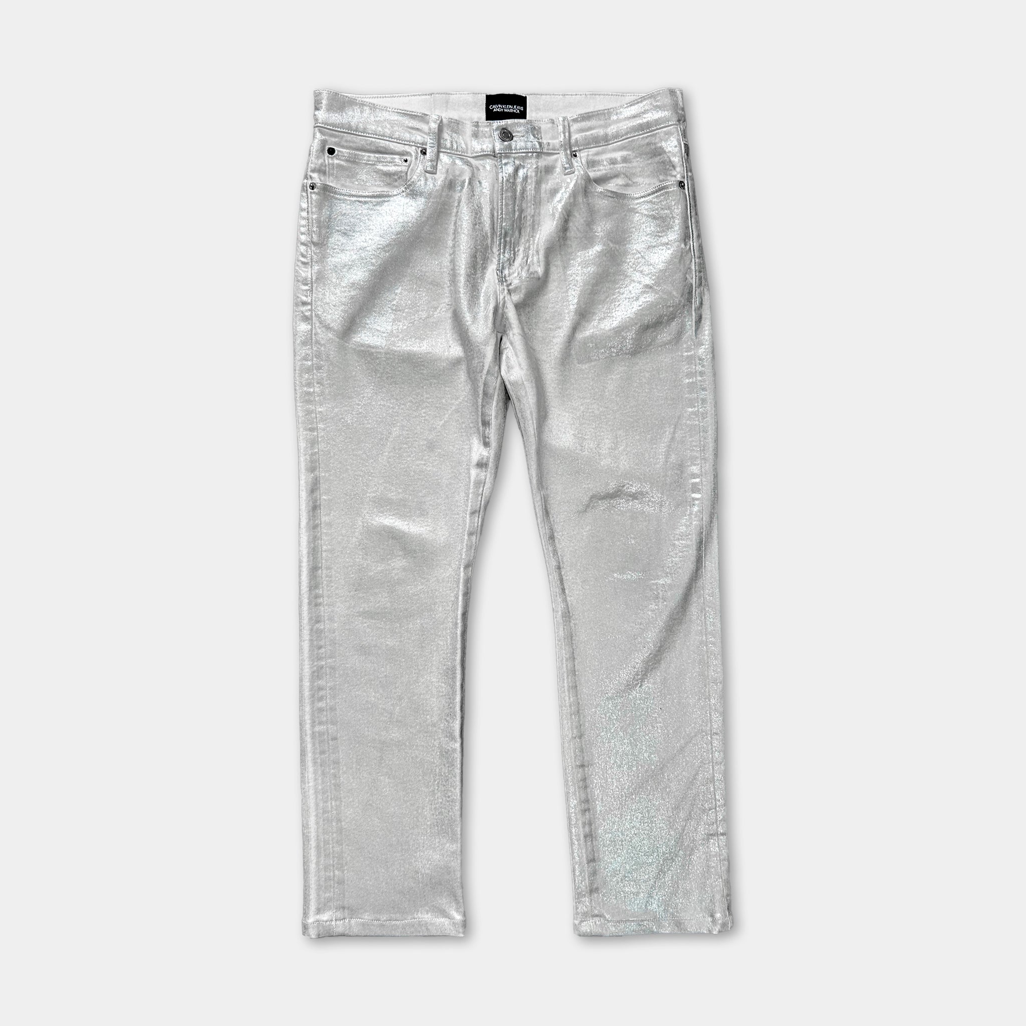 A pair of shiny silver metallic jeans.