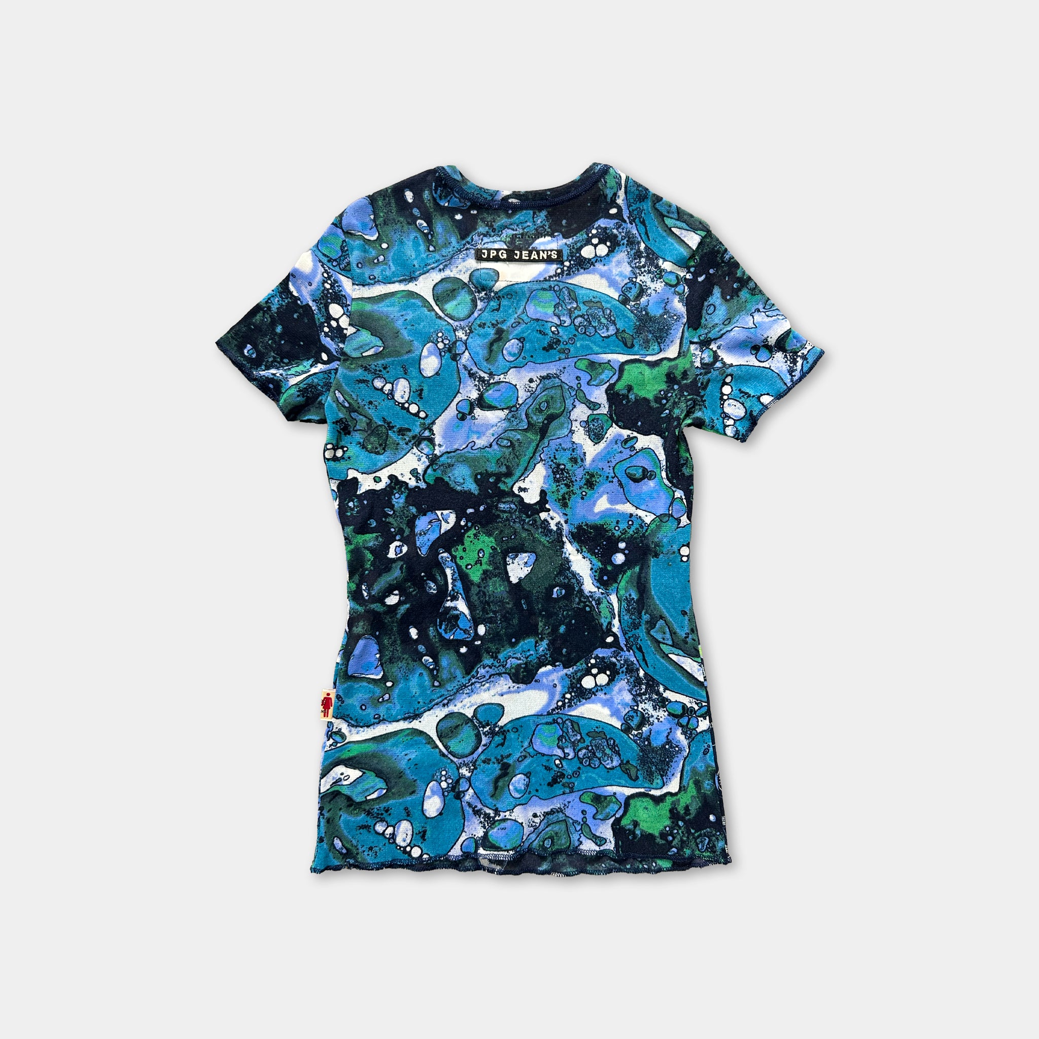 a colorful, abstract patterned t-shirt with a mix of blue, green, and white colors.