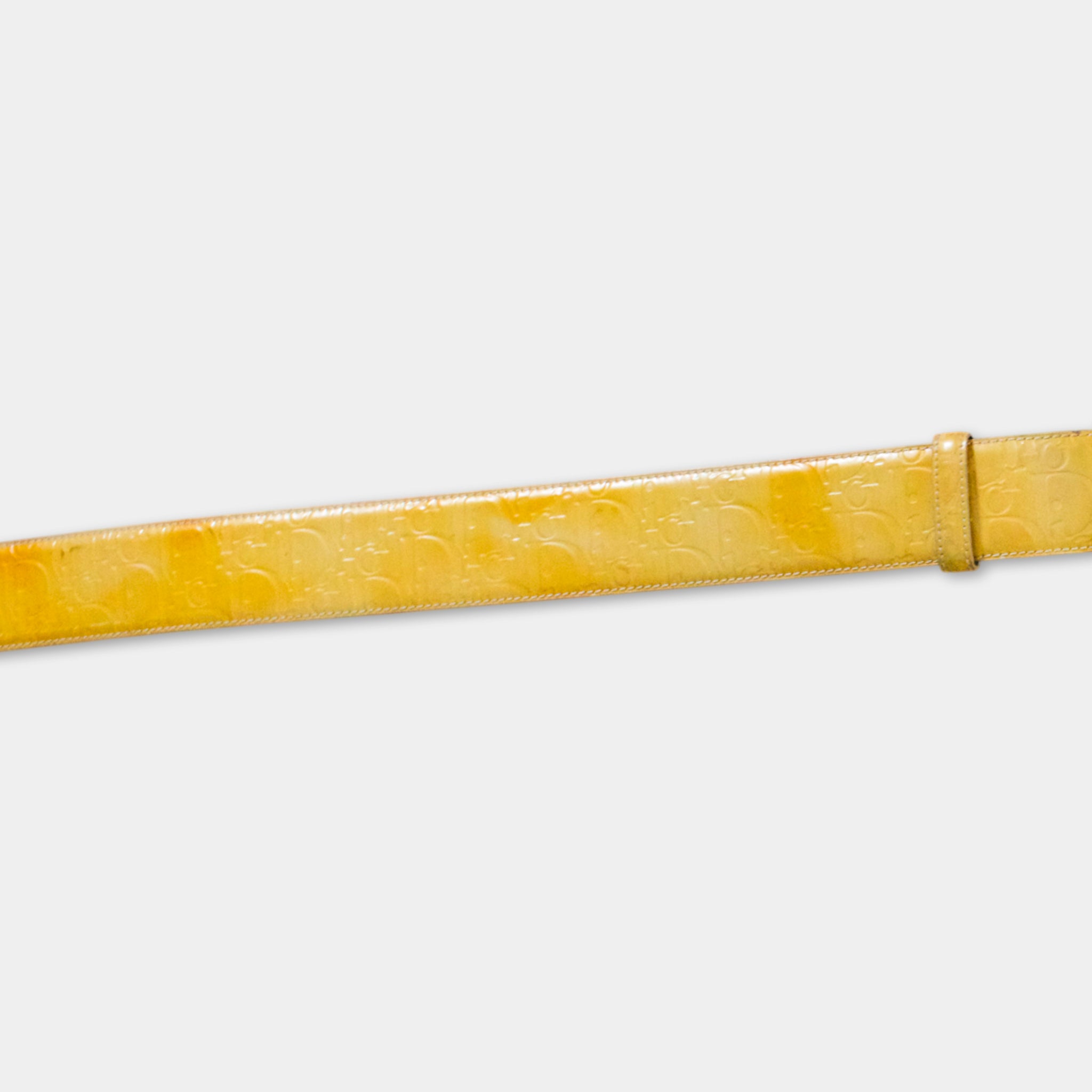 A yellow belt with a patterned design, displayed against a plain white background.
