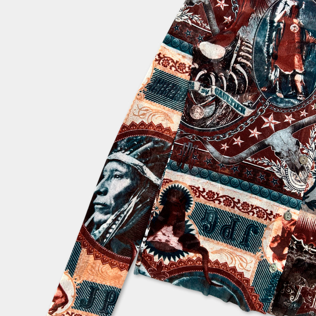 The image is a colorful, patterned fabric with various designs and images, including a Native American headdress, a skull, and other wildlife-inspired elements.