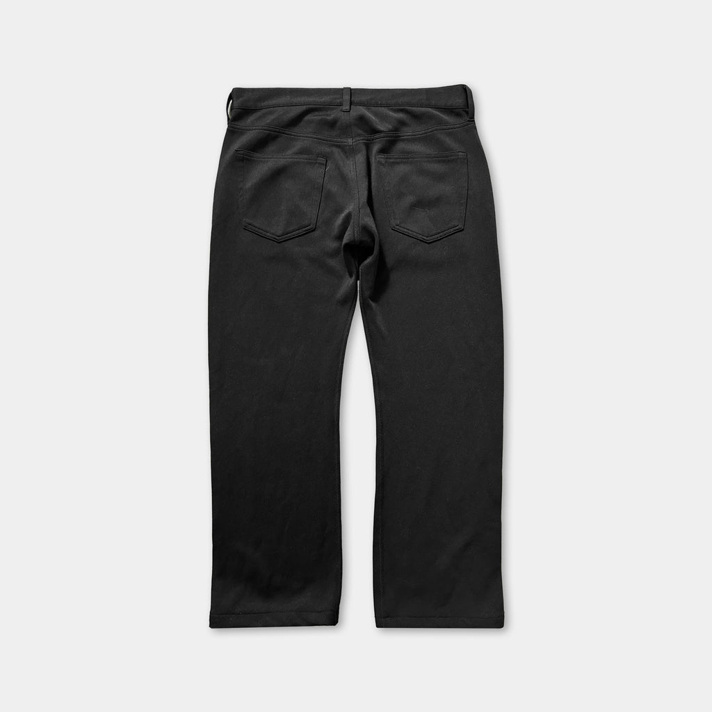 A pair of black pants with a high waist and a button closure.