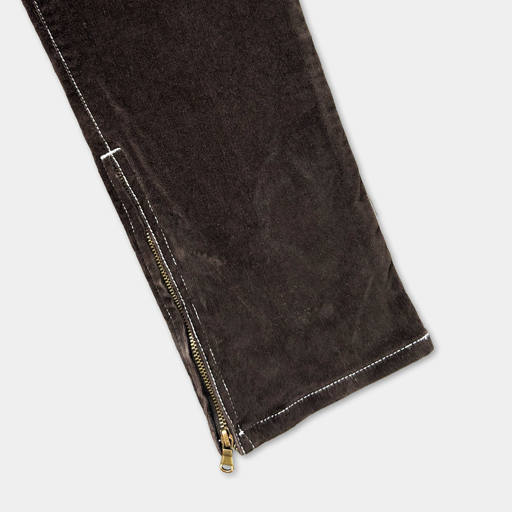 A close-up view of a dark brown fabric, possibly a piece of clothing, with a zipper visible.