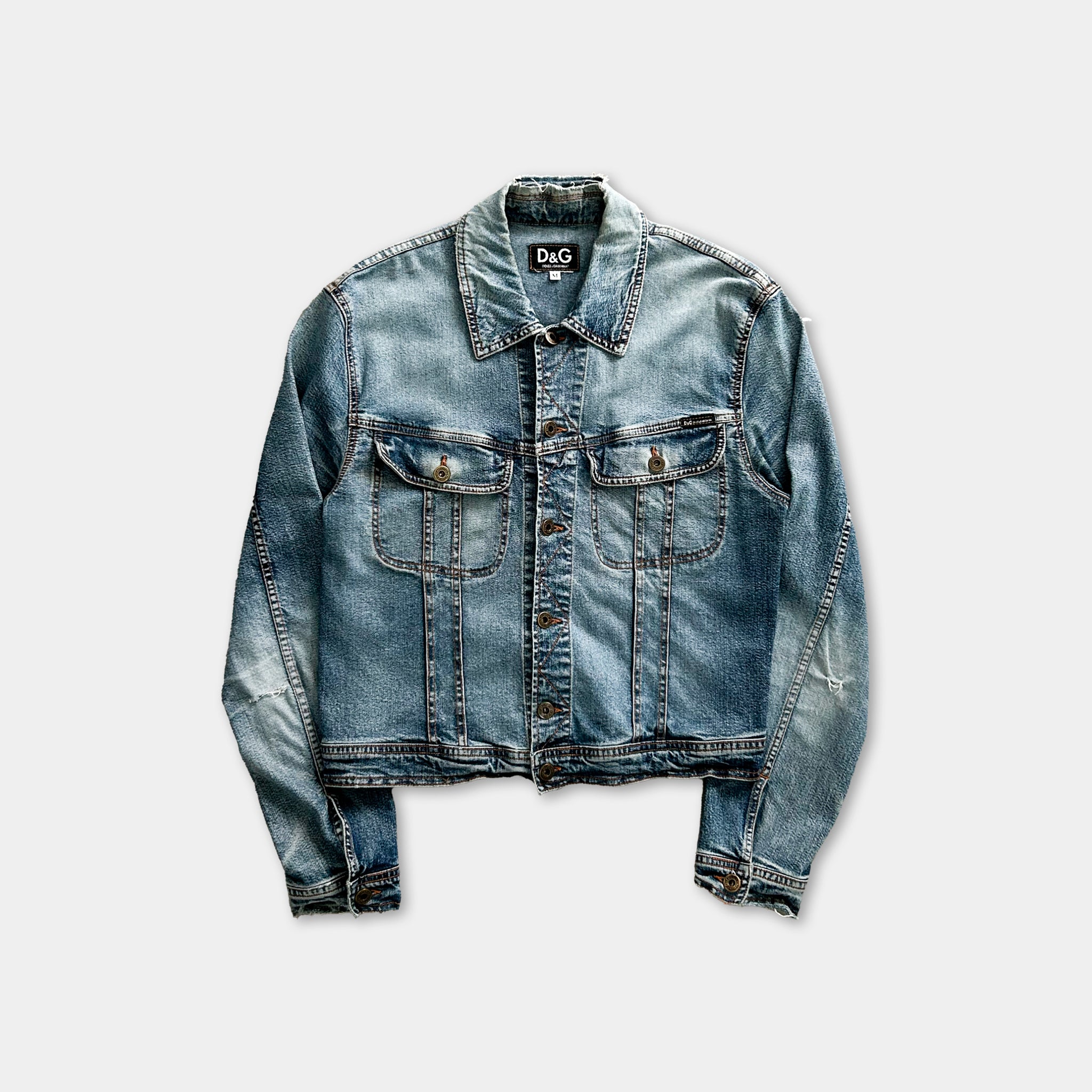 A denim jacket with a collar and two front pockets, displayed against a white background.
