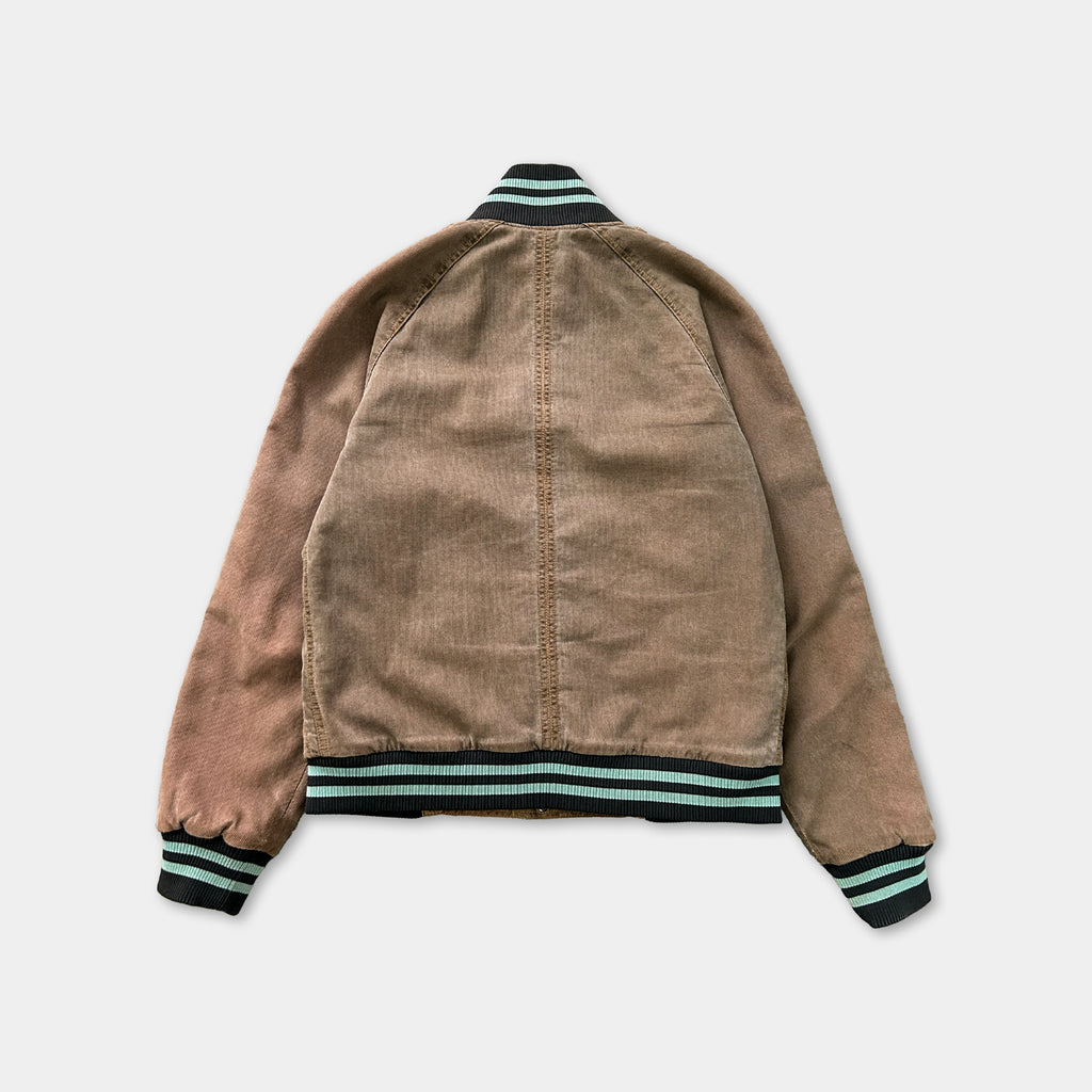 A brown jacket with a black and green trim, featuring a high collar and long sleeves.