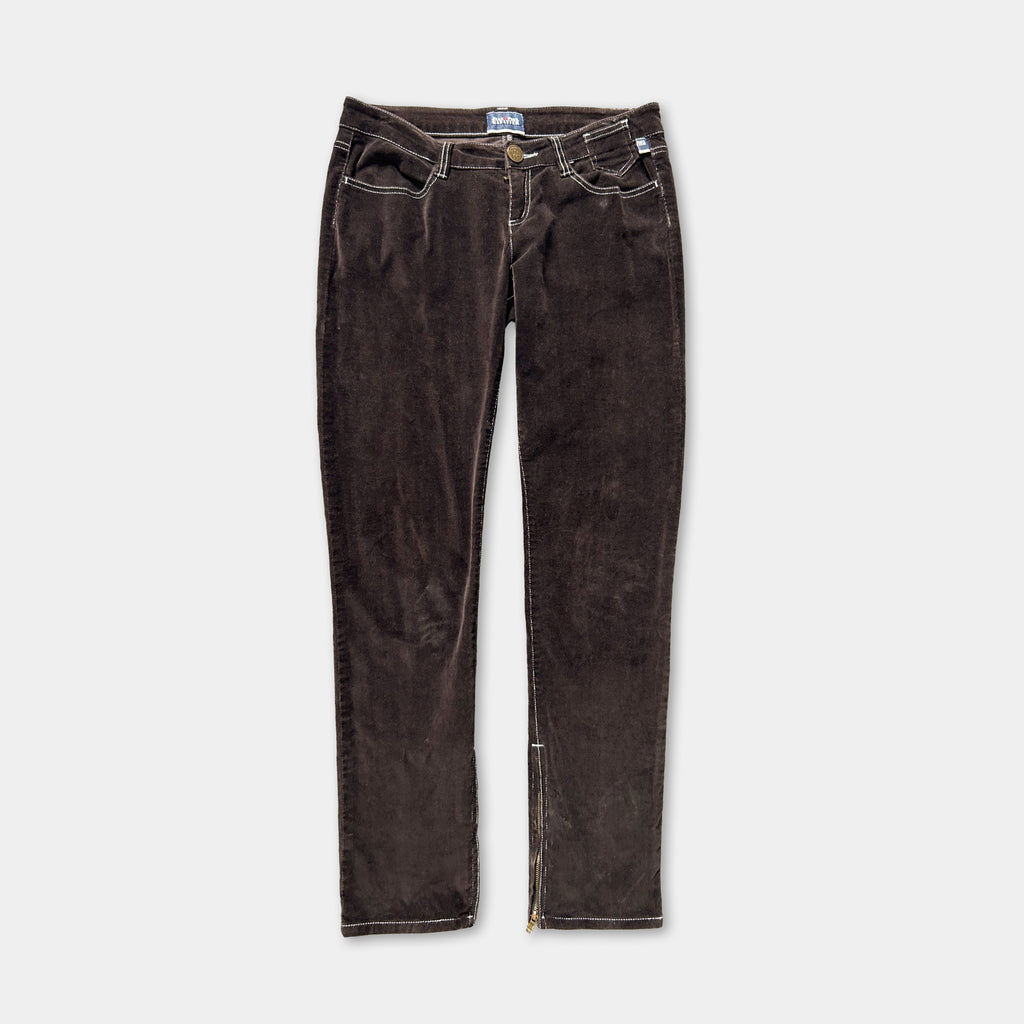 A pair of brown corduroy jeans with a zipper detail on the side.