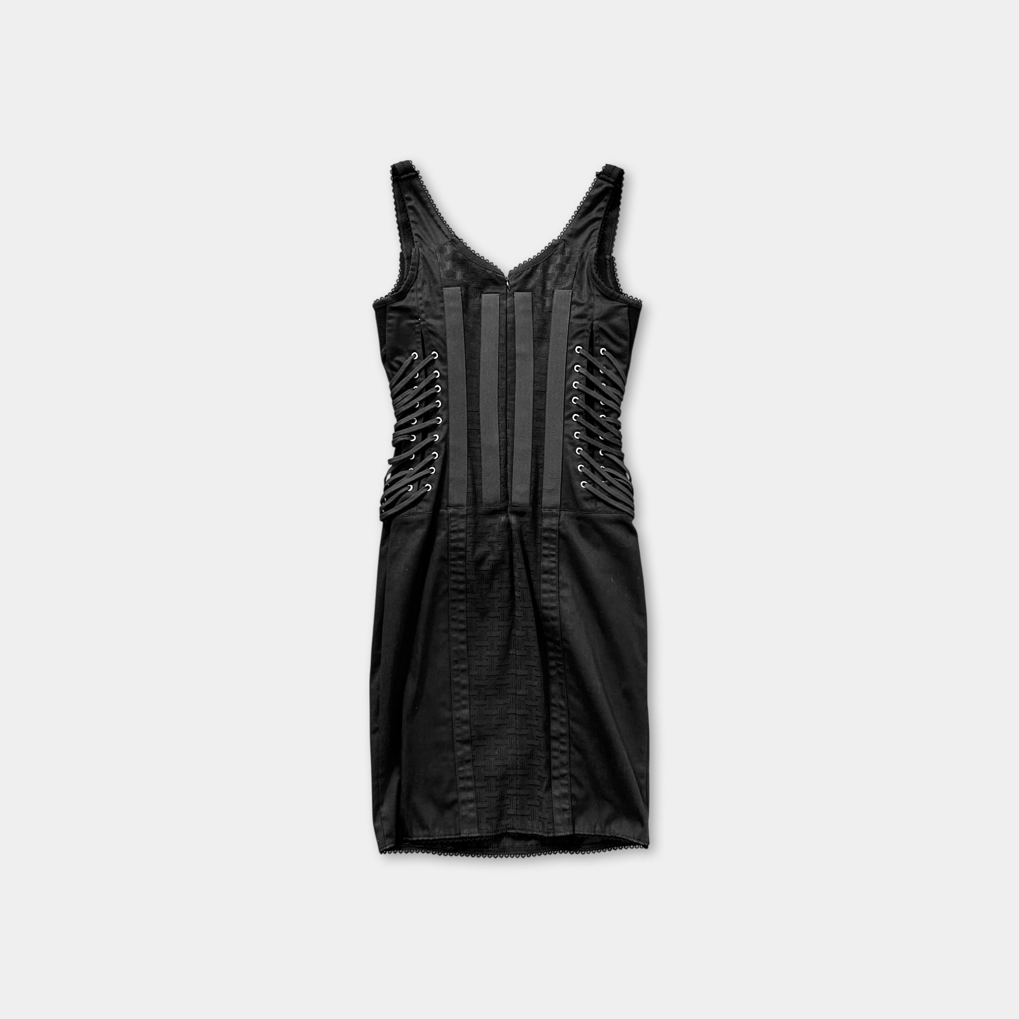 A black dress with lace-up details and a fitted silhouette.