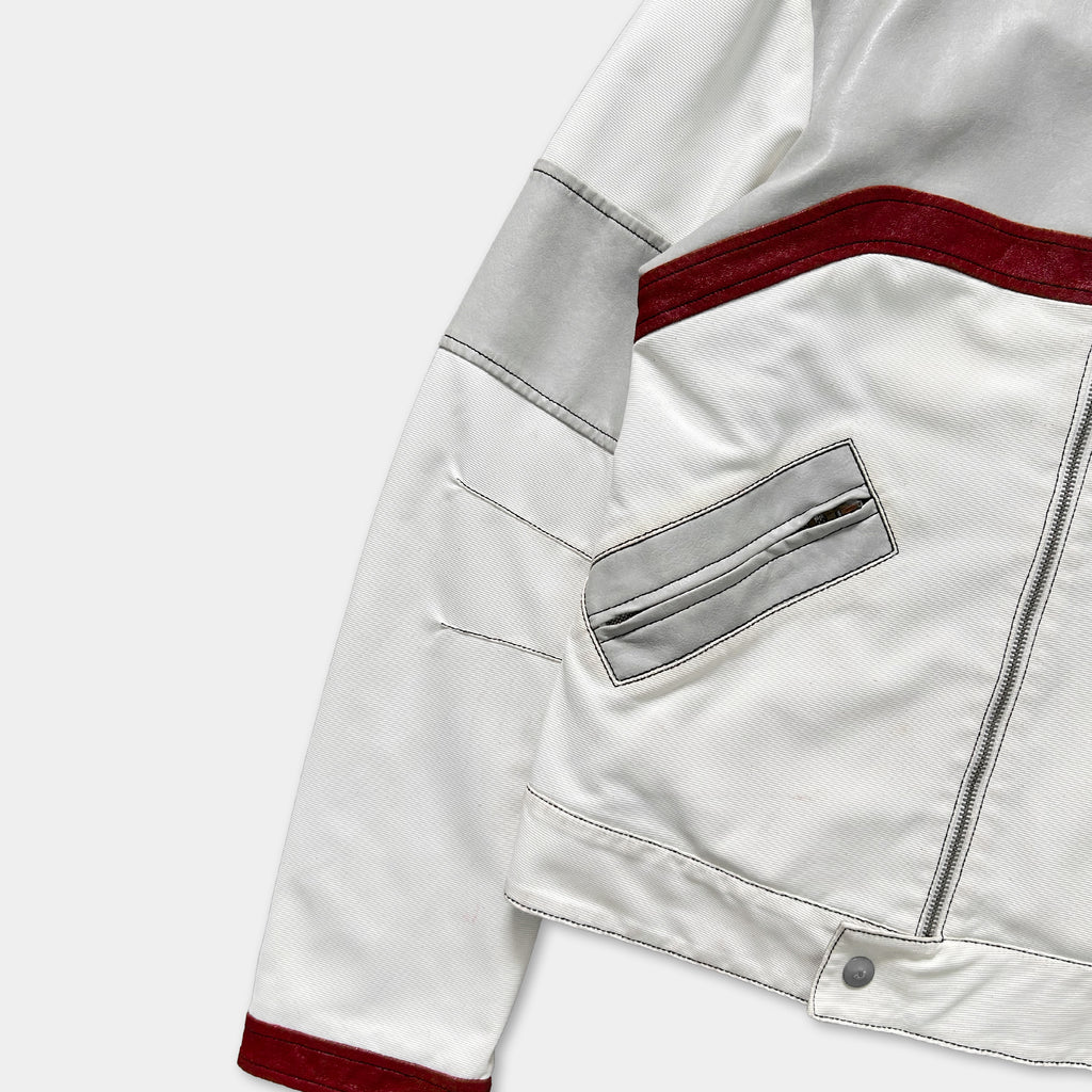 A white and red jacket with a red stripe and a gray pocket is shown in the image.