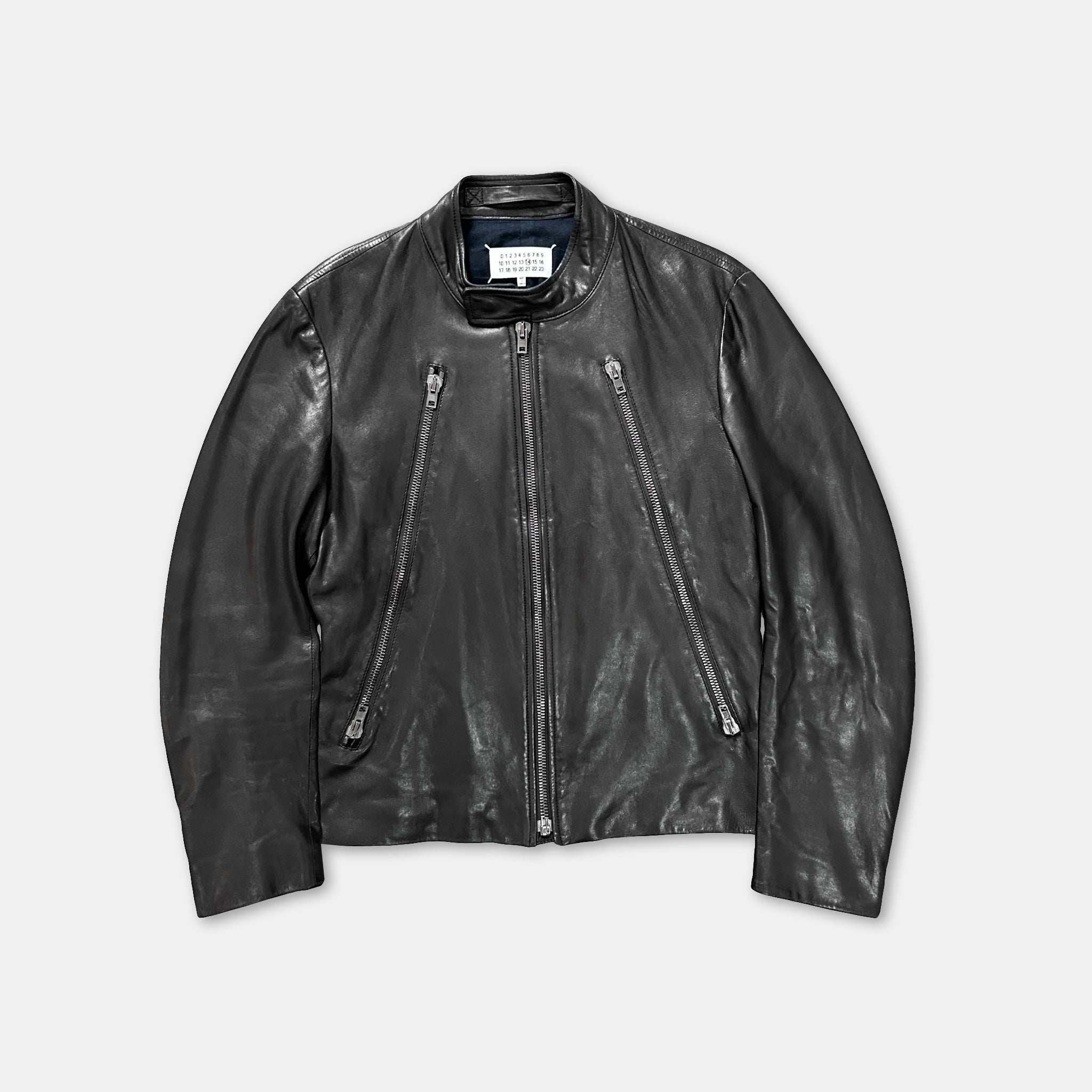 A black leather jacket with multiple zippers and a collar.