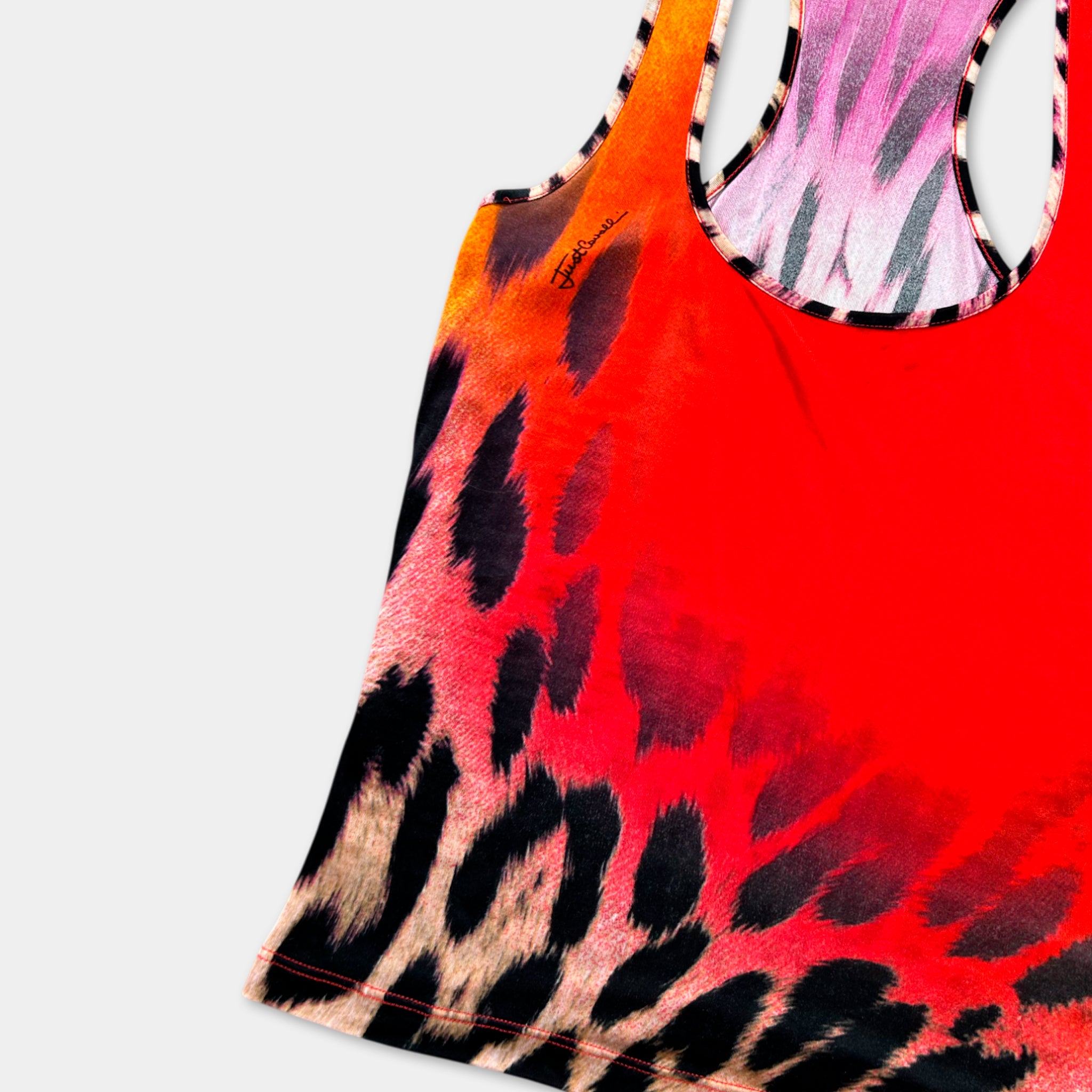 A vibrant, leopard print tank top with bold, multicolored patterns.