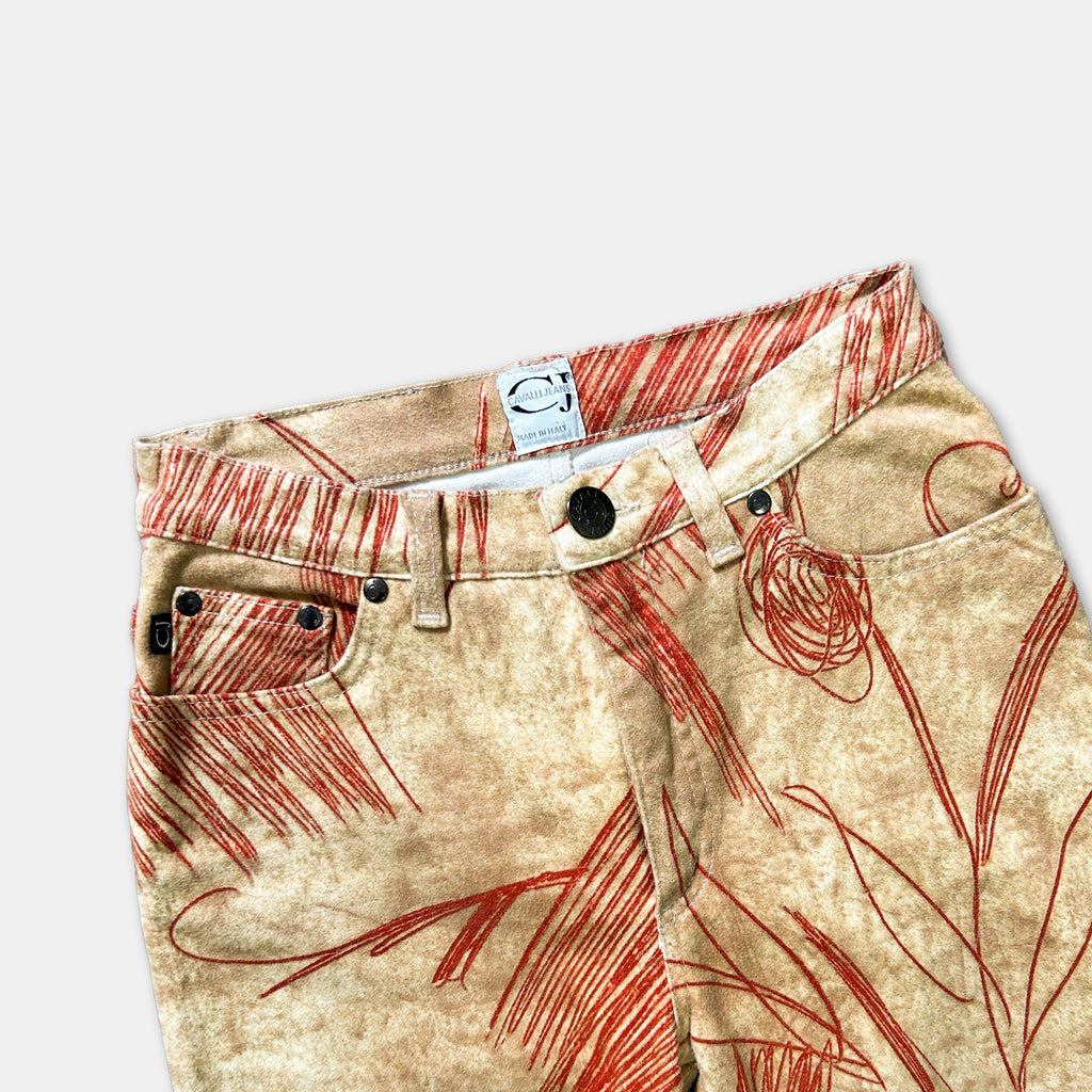 a pair of beige pants with a red and orange floral pattern.