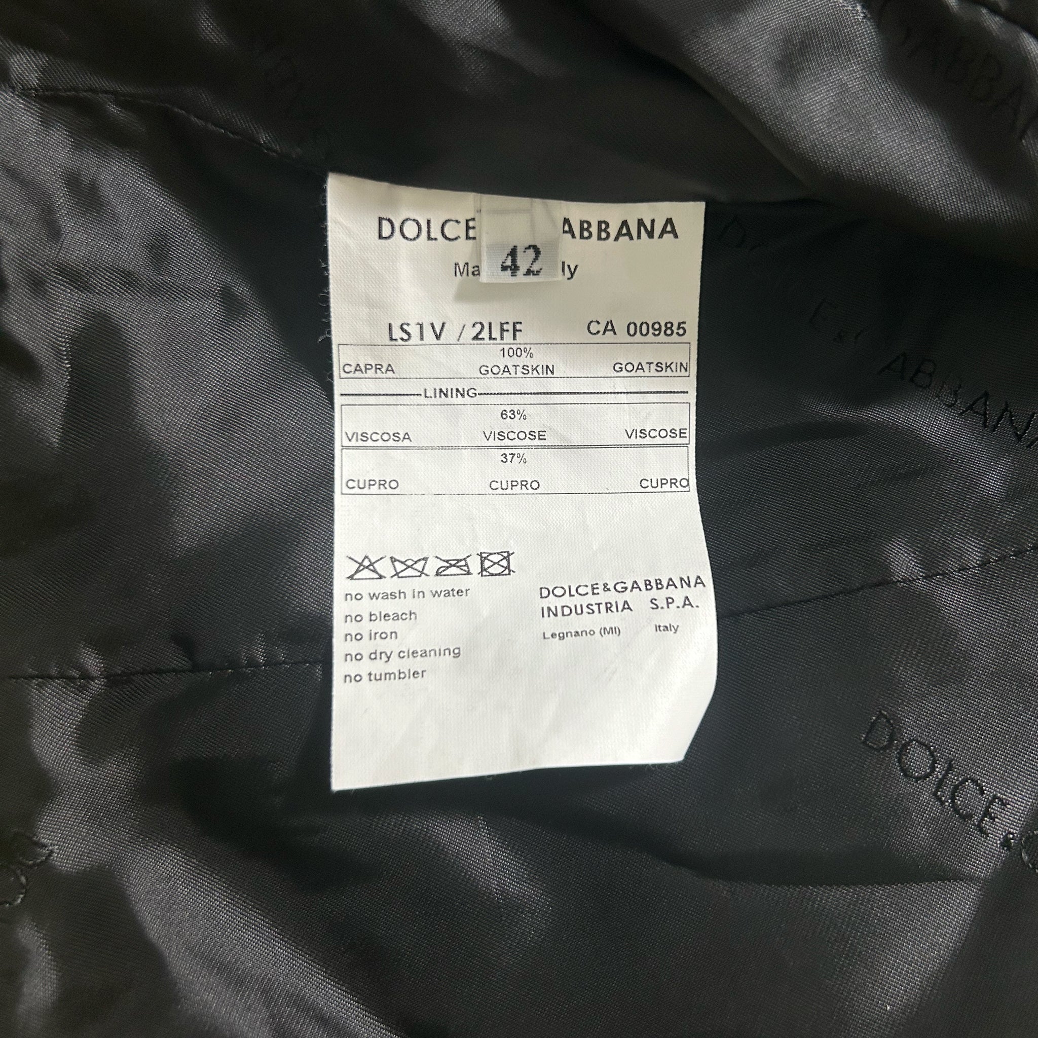 a close-up of a label on a piece of clothing, likely a coat or jacket, with details about the fabric and care instructions.