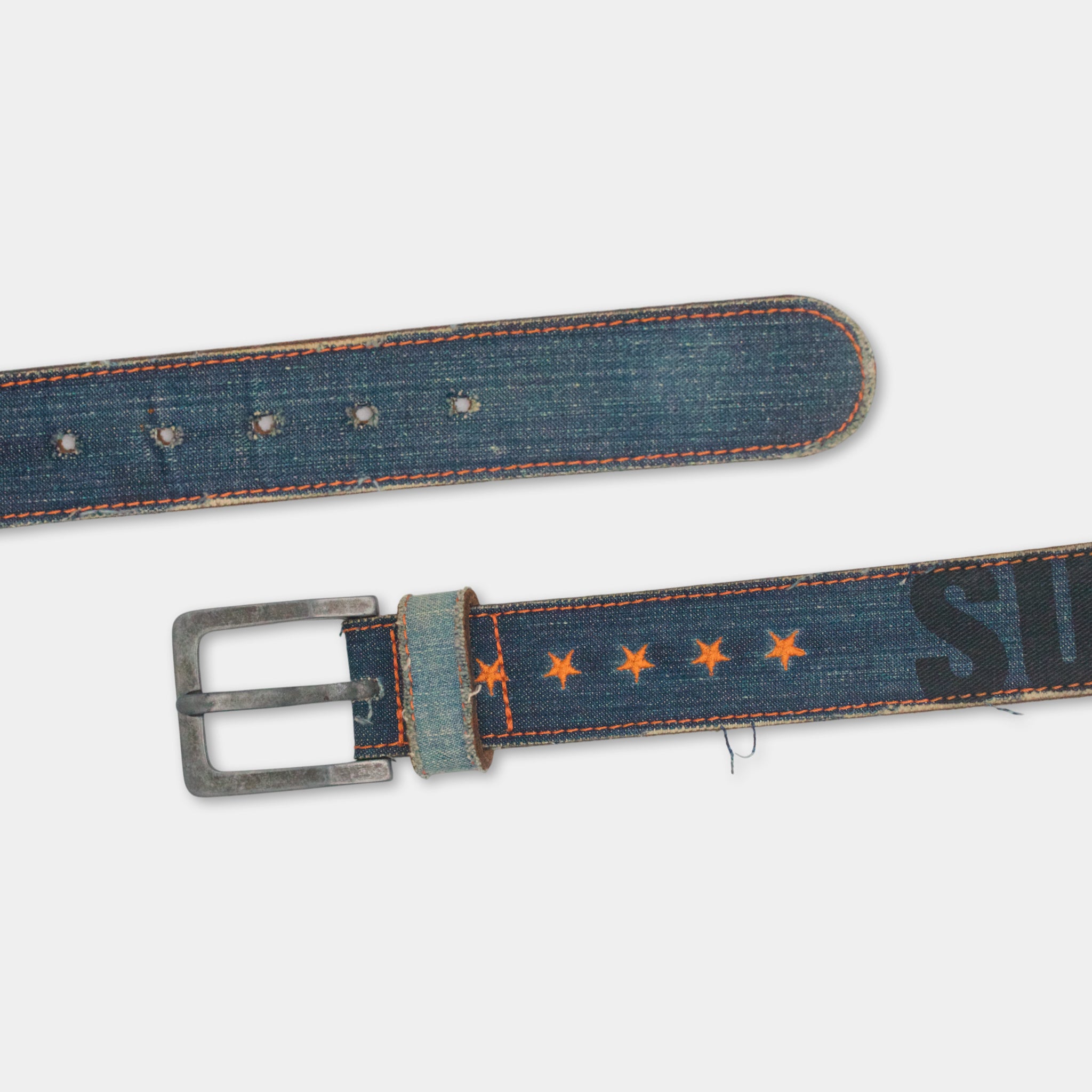 a pair of blue denim belts with orange star patterns on them.