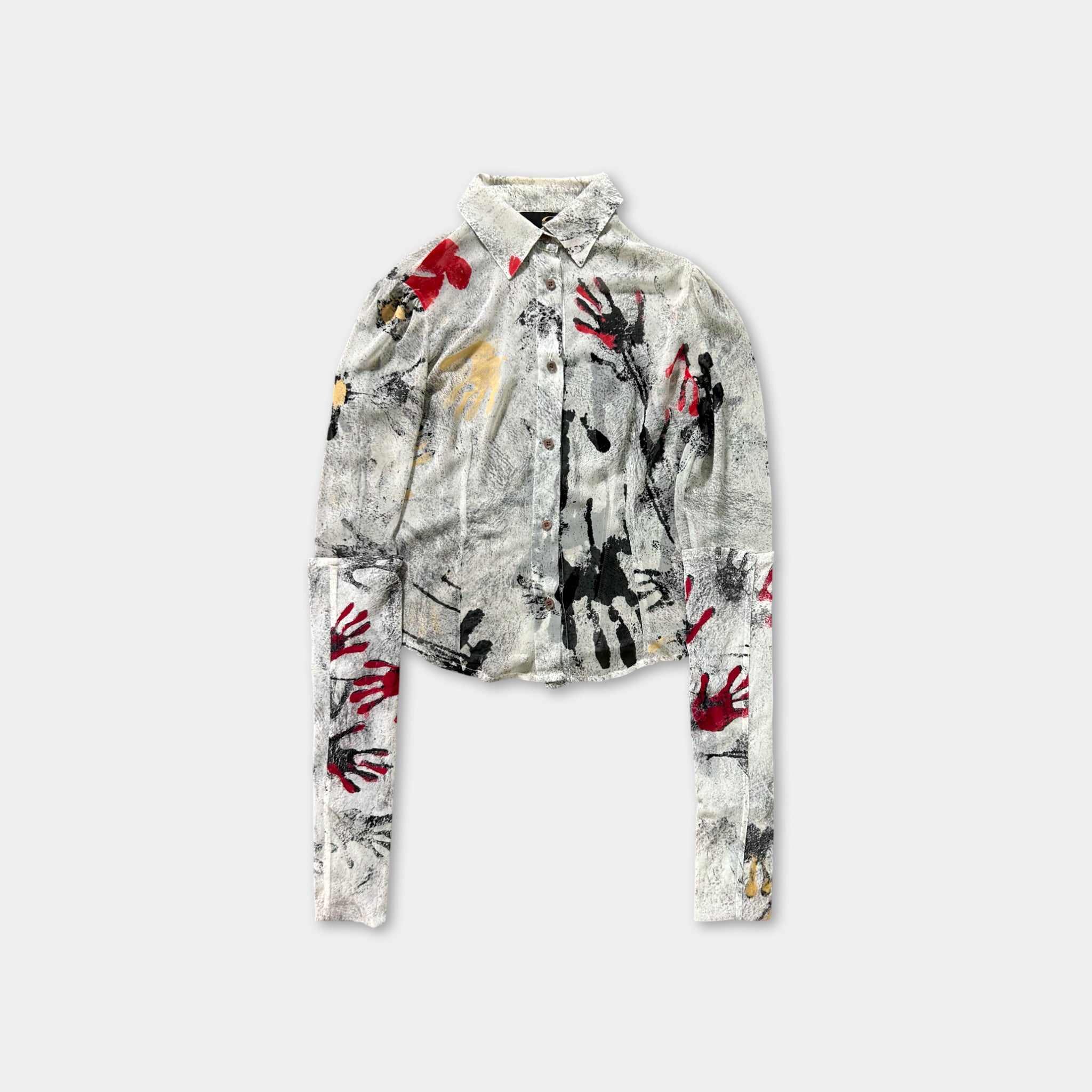 a long-sleeved shirt with a unique, abstract print design on the front.