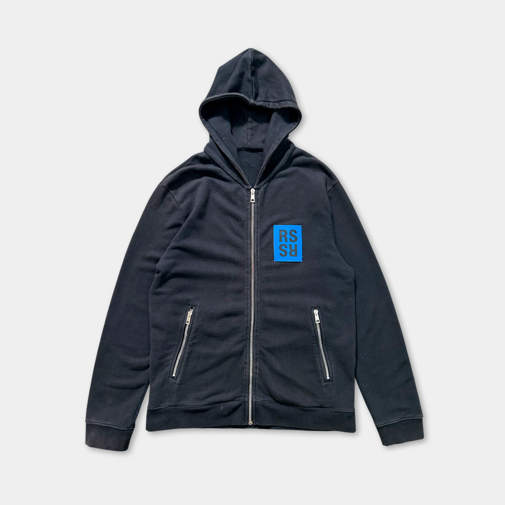 A black zip-up hoodie with a blue square logo on the left side.