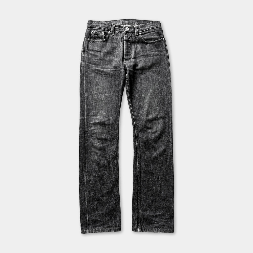 A pair of black, well-worn jeans with visible creases and folds, suggesting they have been worn multiple times.