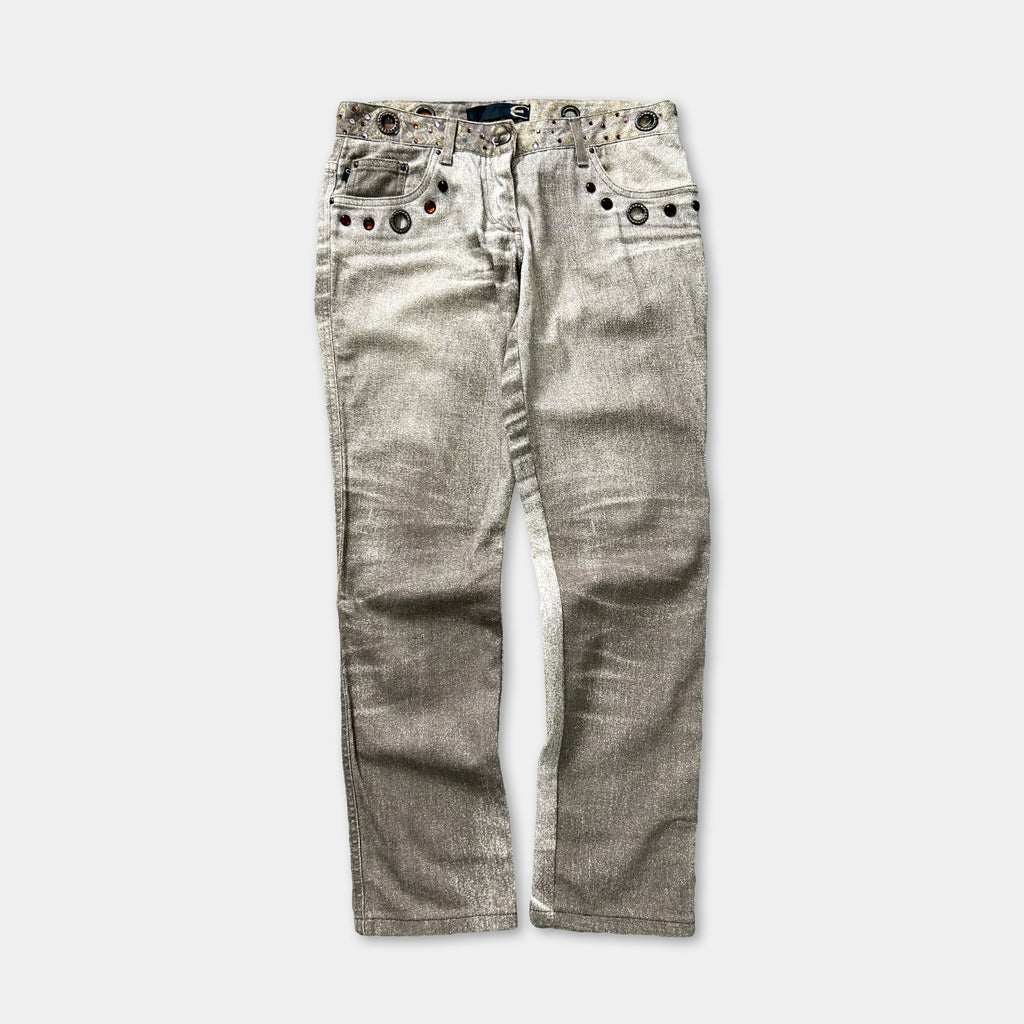 A pair of gray jeans with a metallic, studded belt and pockets.