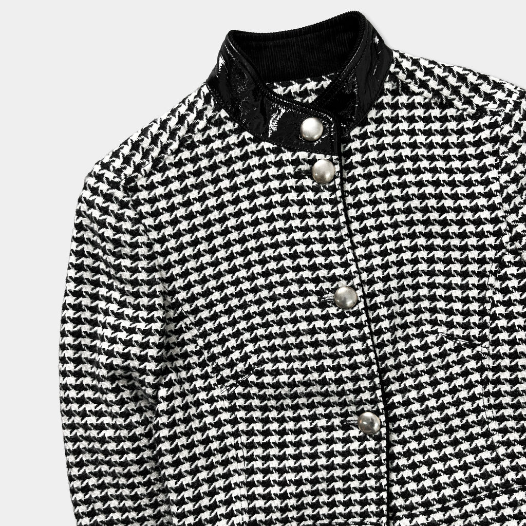 A black and white patterned jacket with a collar and buttons.