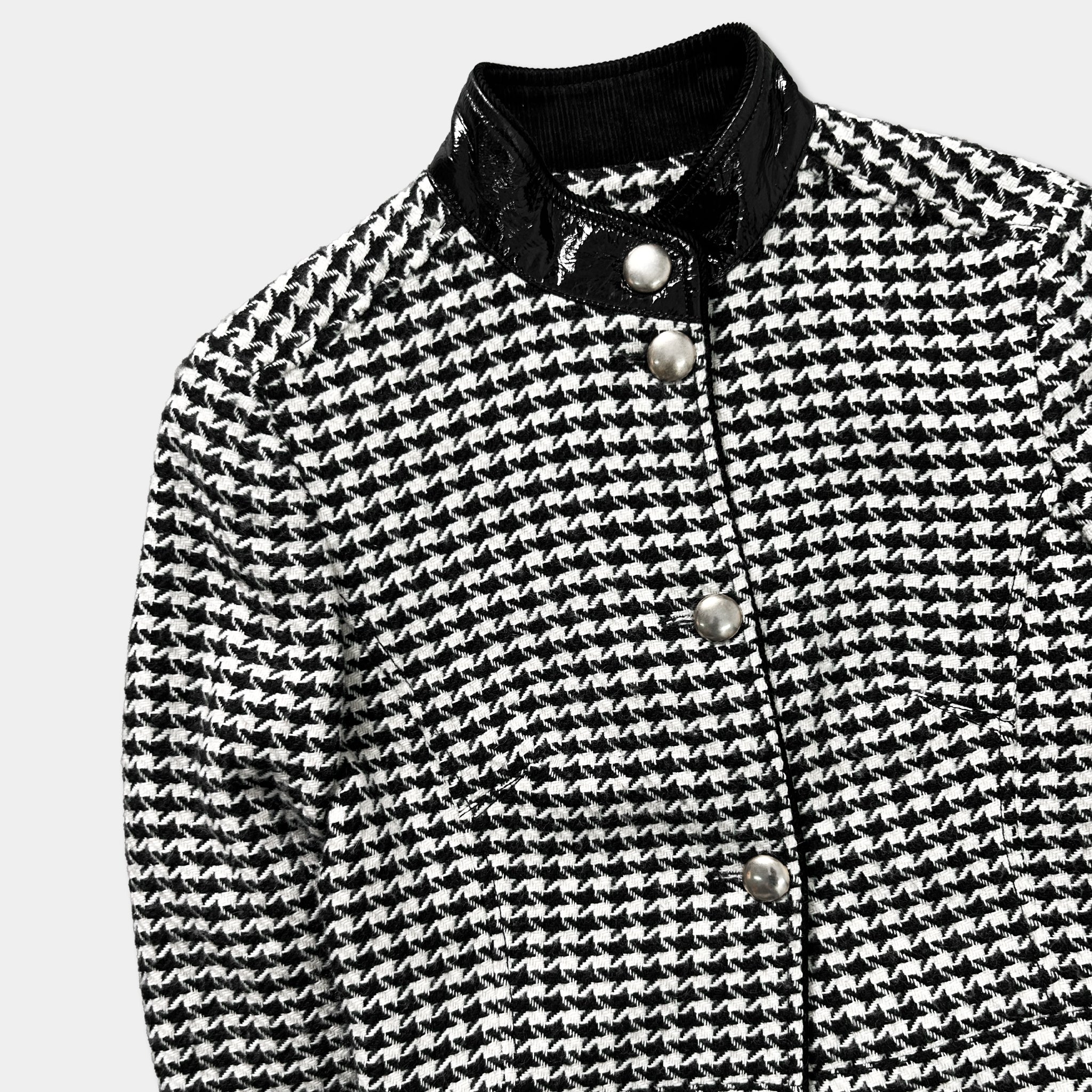 A black and white patterned jacket with a collar and buttons.