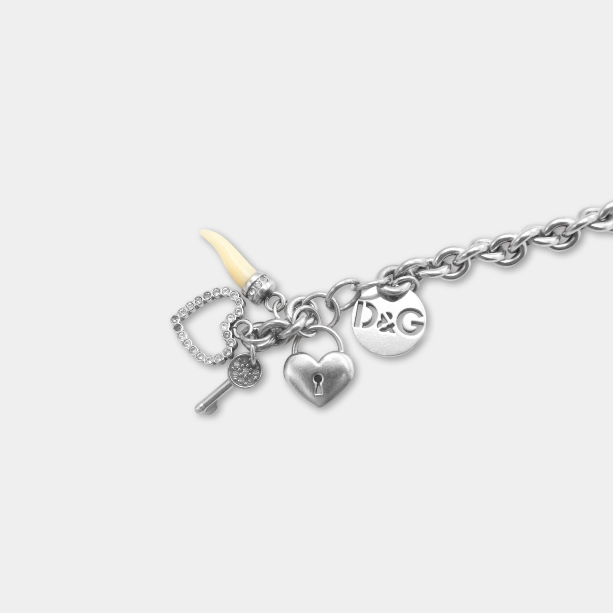 A silver-colored charm bracelet with various charms attached, including a key, heart, and a small pendant.
