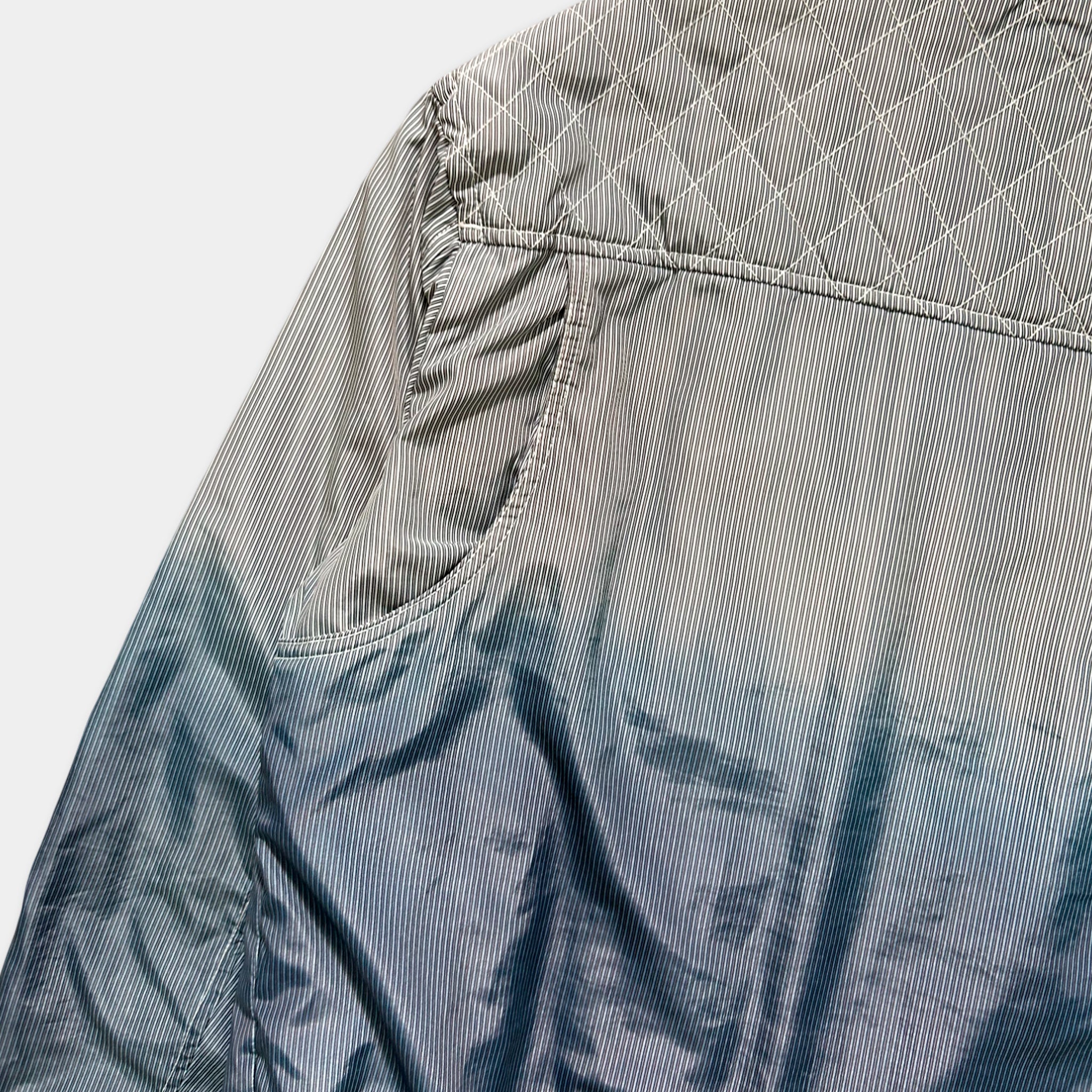 a close-up view of a striped jacket, with the sleeves and collar visible.