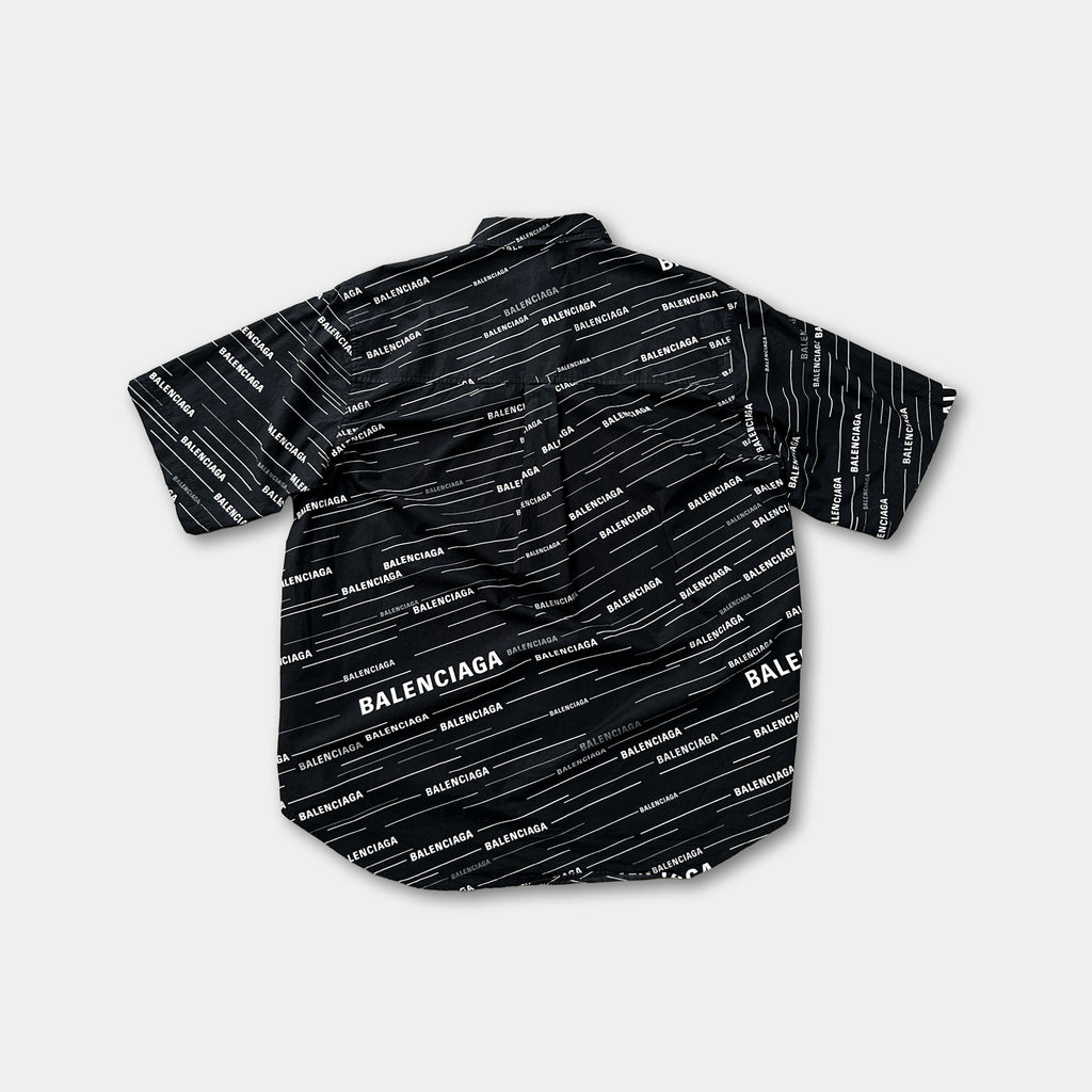 a black and white patterned shirt with the word "BALENCIAGA" printed on it.