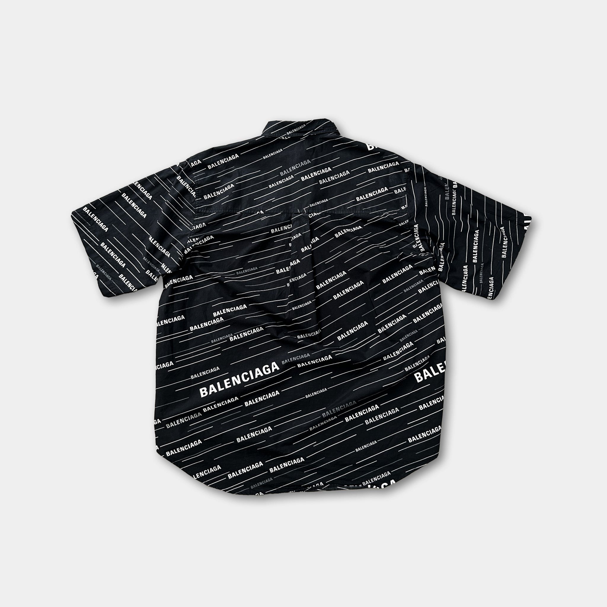 a black and white patterned shirt with the word "BALENCIAGA" printed on it.