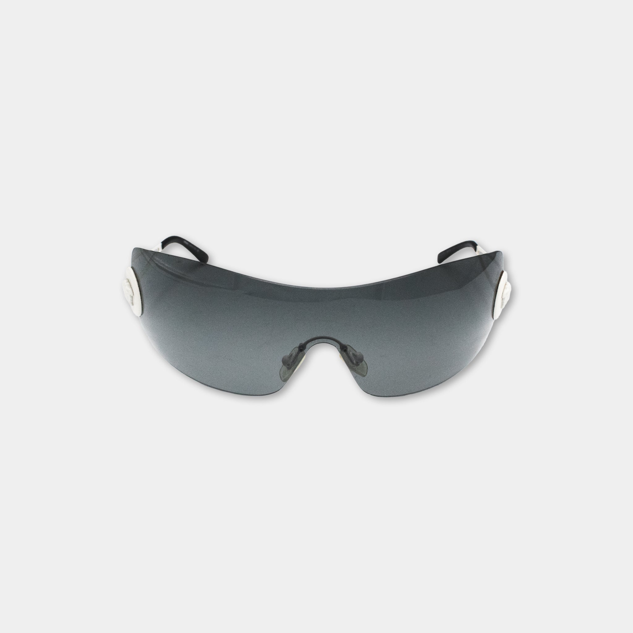 A pair of dark-colored sunglasses with a sleek, modern design.