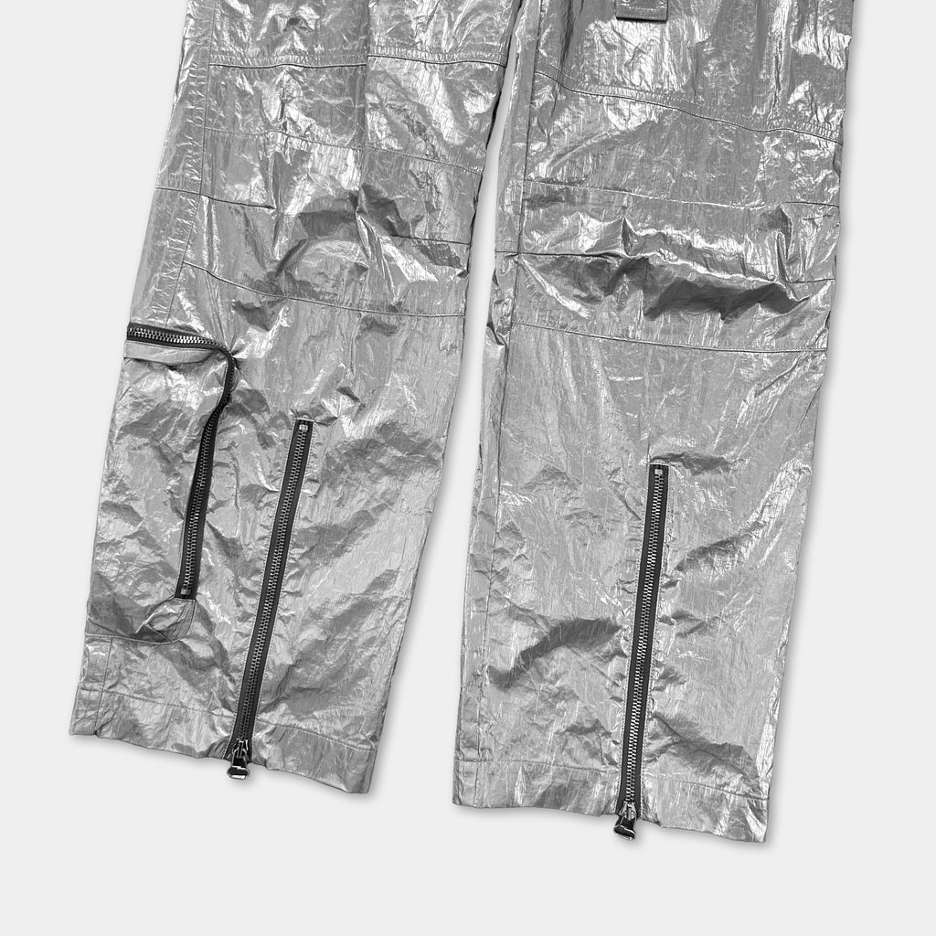 a pair of silver pants with multiple zippers and pockets.