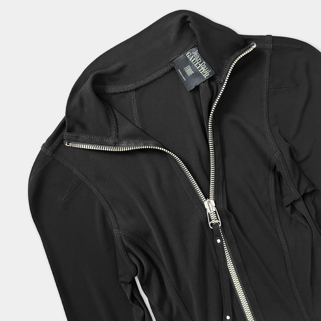 A black zip-up jacket with a zipper pull and a label on the collar.